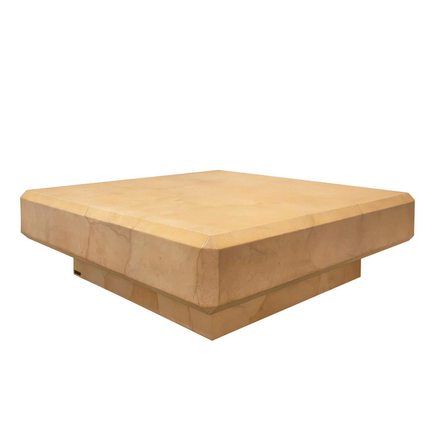 Beautifully made square coffee table in lacquered goatskin on a recessed plinth base by Karl Springer, American 1980's (signed with label that reads “Karl Springer” on base). The coloration of the goatskin is beautiful. This table was crafted with