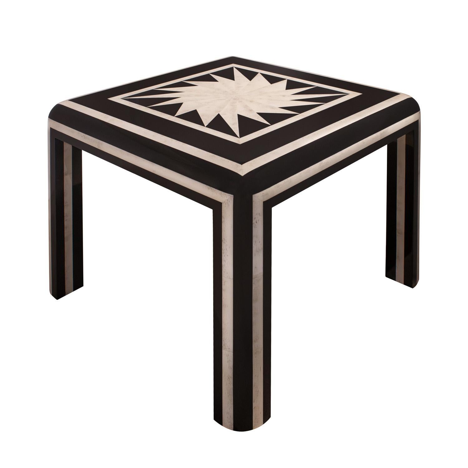 Stunning game table in high gloss black lacquer with tessellated bone inlays and inlaid radiating starburst pattern on top in bone by Karl Springer, American 1980's. The attention to detail is meticulous, the craftsmanship is superb, and the