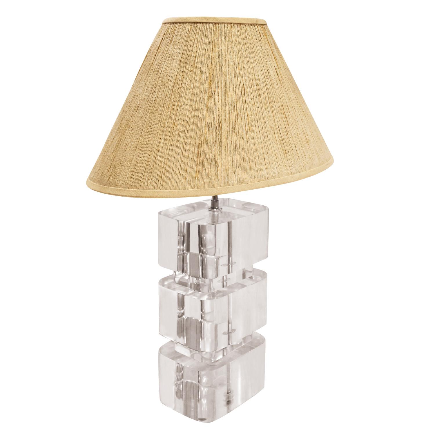 Iconic table lamp with stacked solid lucite slabs with radius corners and chrome hardware and double socket assembly by Karl Springer, American 1980's.  This lamp comes with the original string shade.  A timeless Karl Springer design.