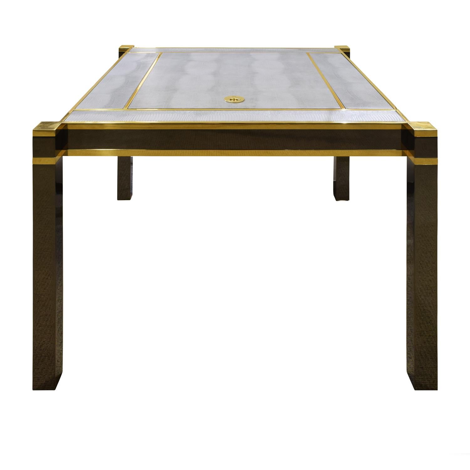 Exceptional “Square Leg Game Table” in polished gunmetal and brass with light gray embossed lizard leather inset top panels with backgammon board under removable cover by Karl Springer, American, 1970’s. This piece, combining meticulous metal