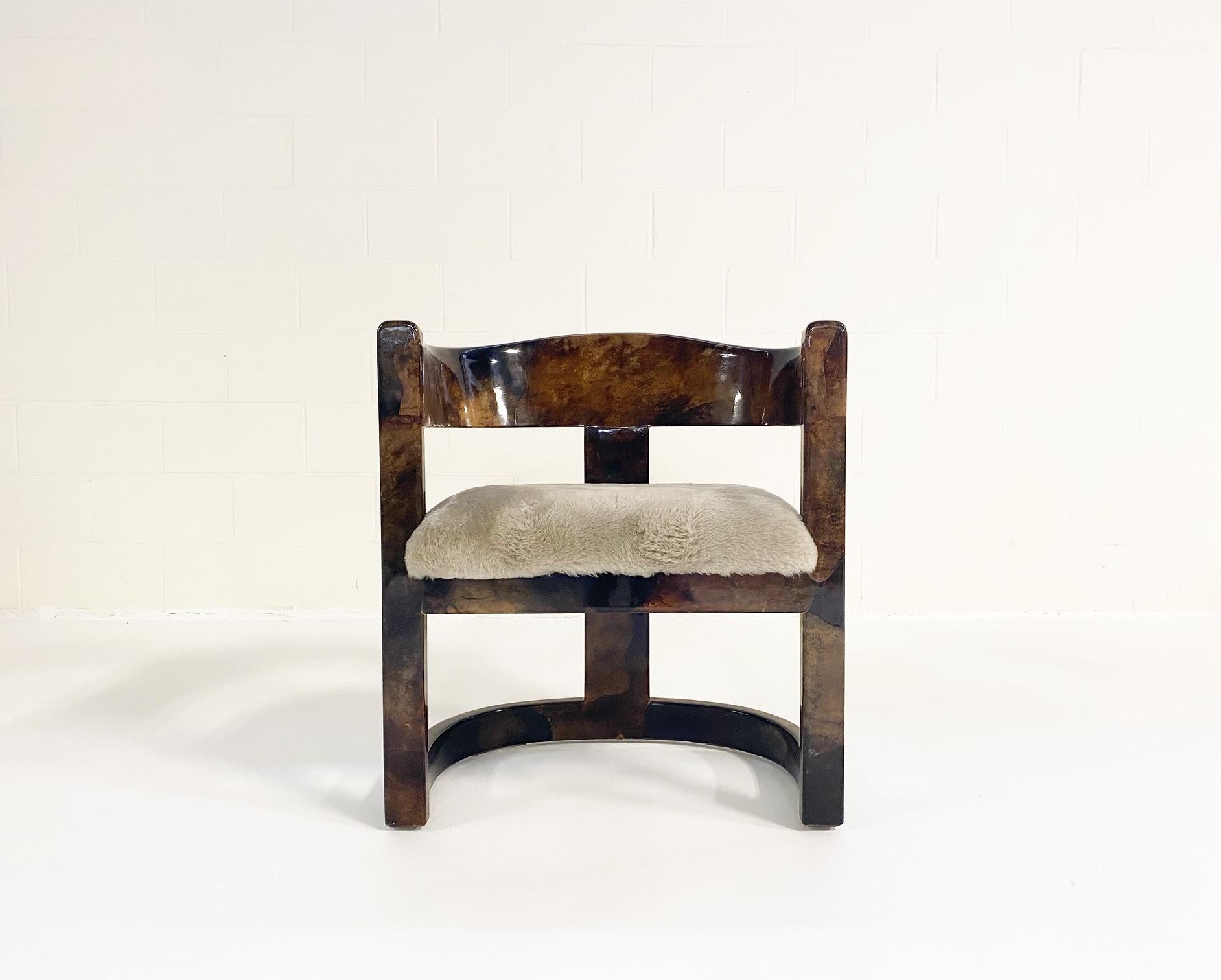 Karl Springer's furniture wrapped in lacquered skins—goat, lizard, alligator, shagreen, python, and even frog—were his most distinct pieces. This beautiful Springer armchair is made of lacquered goatskin. The thick lacquer creates a very cool,