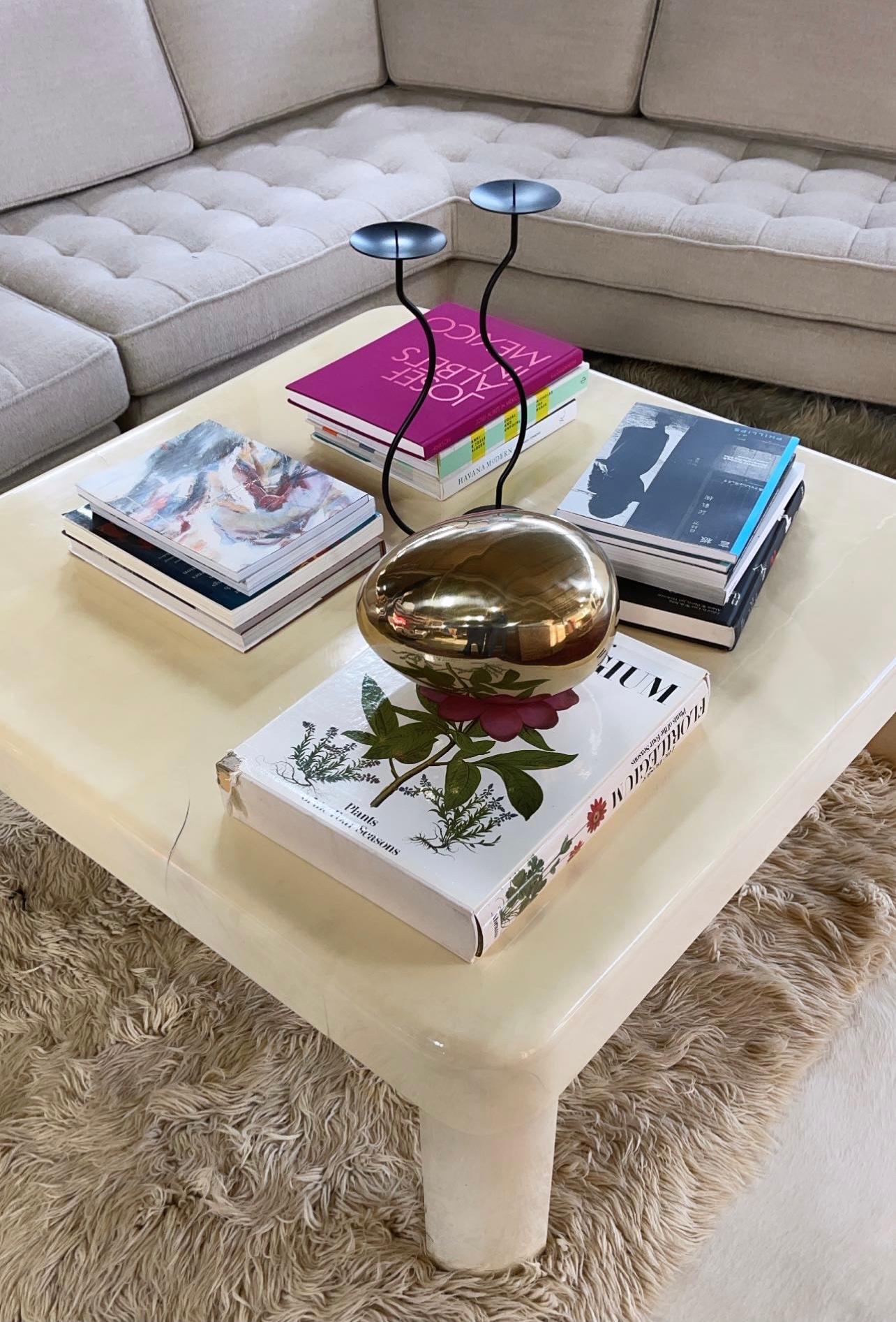 Karl Springer's furniture wrapped in lacquered skins—goat, lizard, alligator, shagreen, python, and even frog—were his most distinct pieces. This beautiful Springer coffee table is made of lacquered goatskin. The thick lacquer creates a very cool,