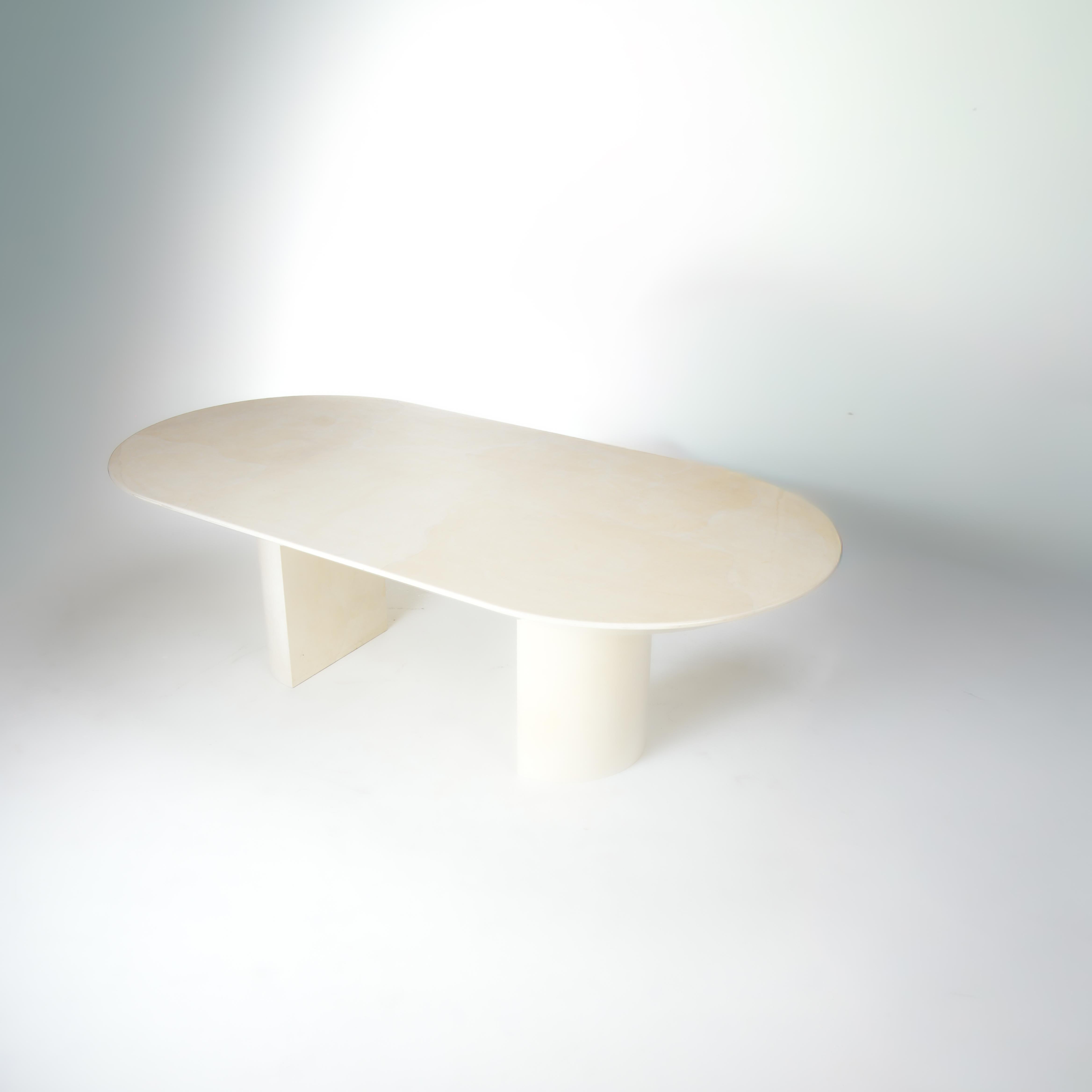 Oval ivory-colored goatskin and lacquer dinning table designed by Karl Springer featuring thick rounded table legs.
Karl Springer developed an irreverent and non-doctrinaire idiom of bold proportions, and often highly exotic finishes. His work