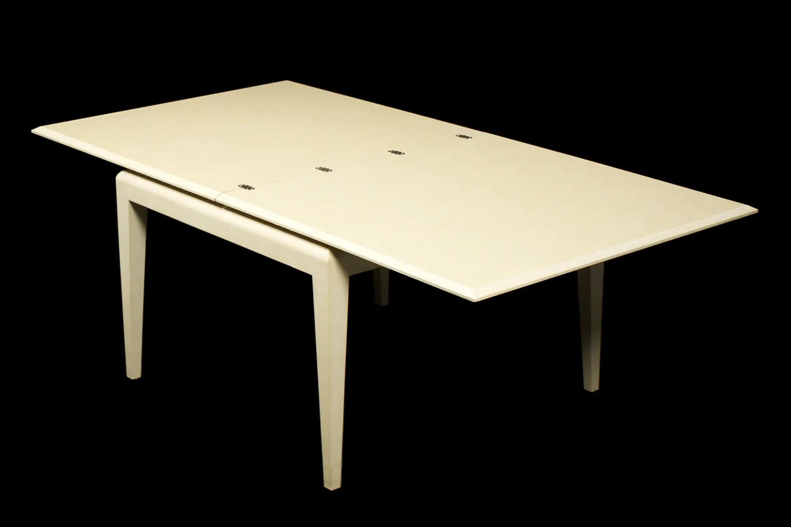 An elegant and versatile Karl Springer flip-top games table in ivory parchment (lacquered goatskin), dating from the 1970s. The table showcases Springer’s signature mastery of luxurious materials and clean-lined forms. The square top lifts and