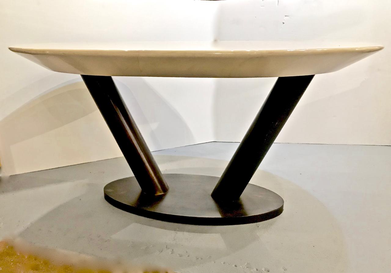 This is a very unusual Karl Springer lacquered goat skin table featuring a modernist steel base supporting a cream lacquered goatskin/parchment top. The table measures 60