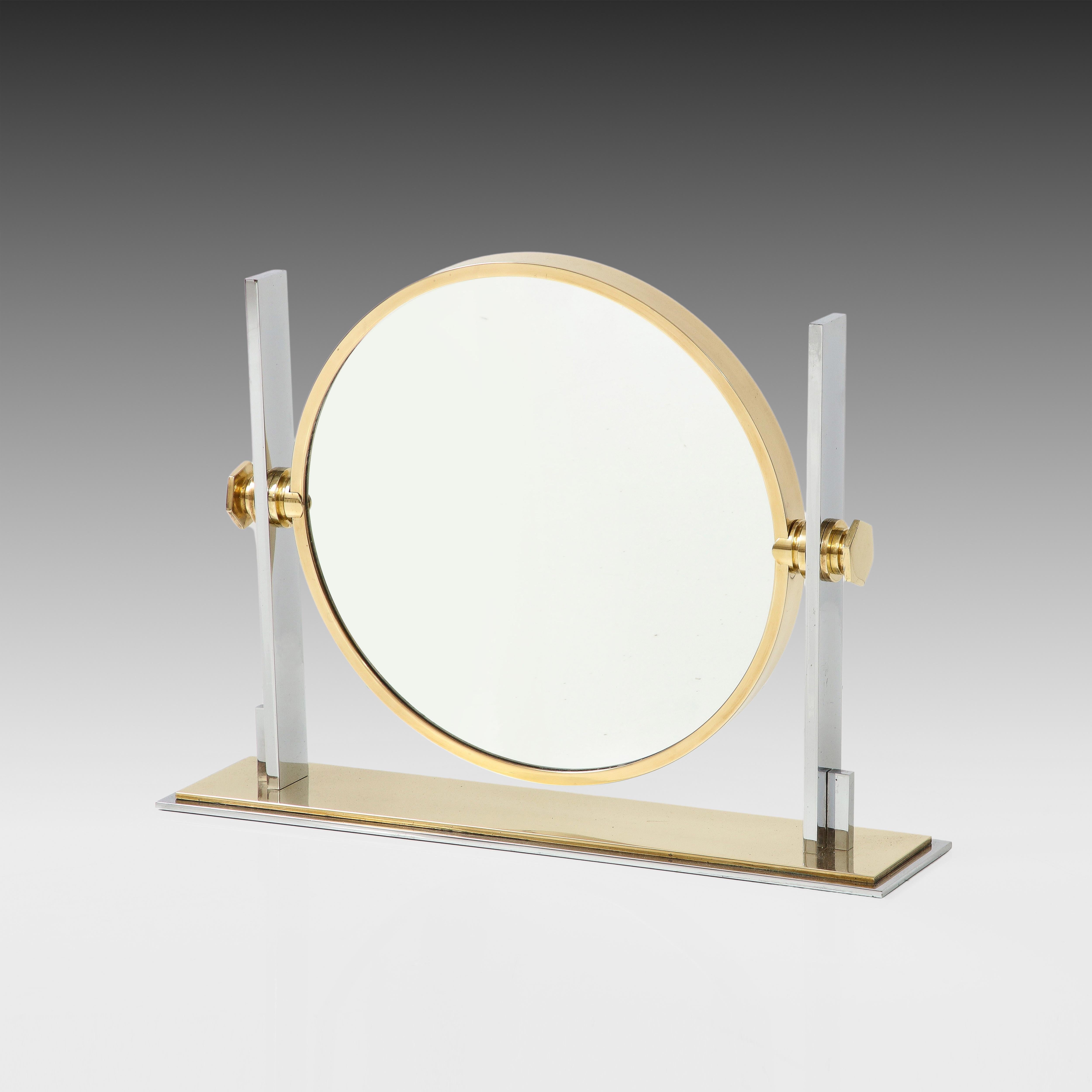 Karl Springer large modernist vanity or table mirror in polished brass and chrome with one side a magnifying mirror and the other side a standard mirror. This chic and iconic Springer vanity mirror design is the larger model and is bold and striking