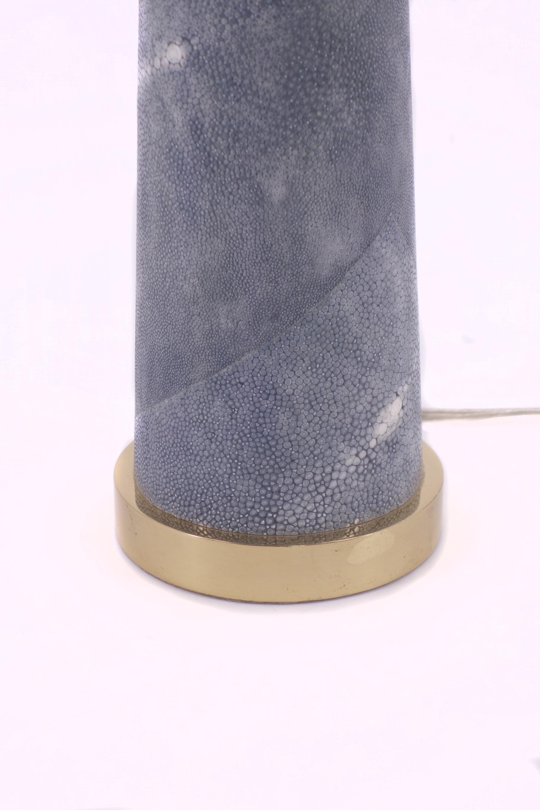 ‘Lighthouse’ table lamp designed by Karl Springer.
This cone shaped lamp is covered by Pale Blue Shagreen with brass details.

 