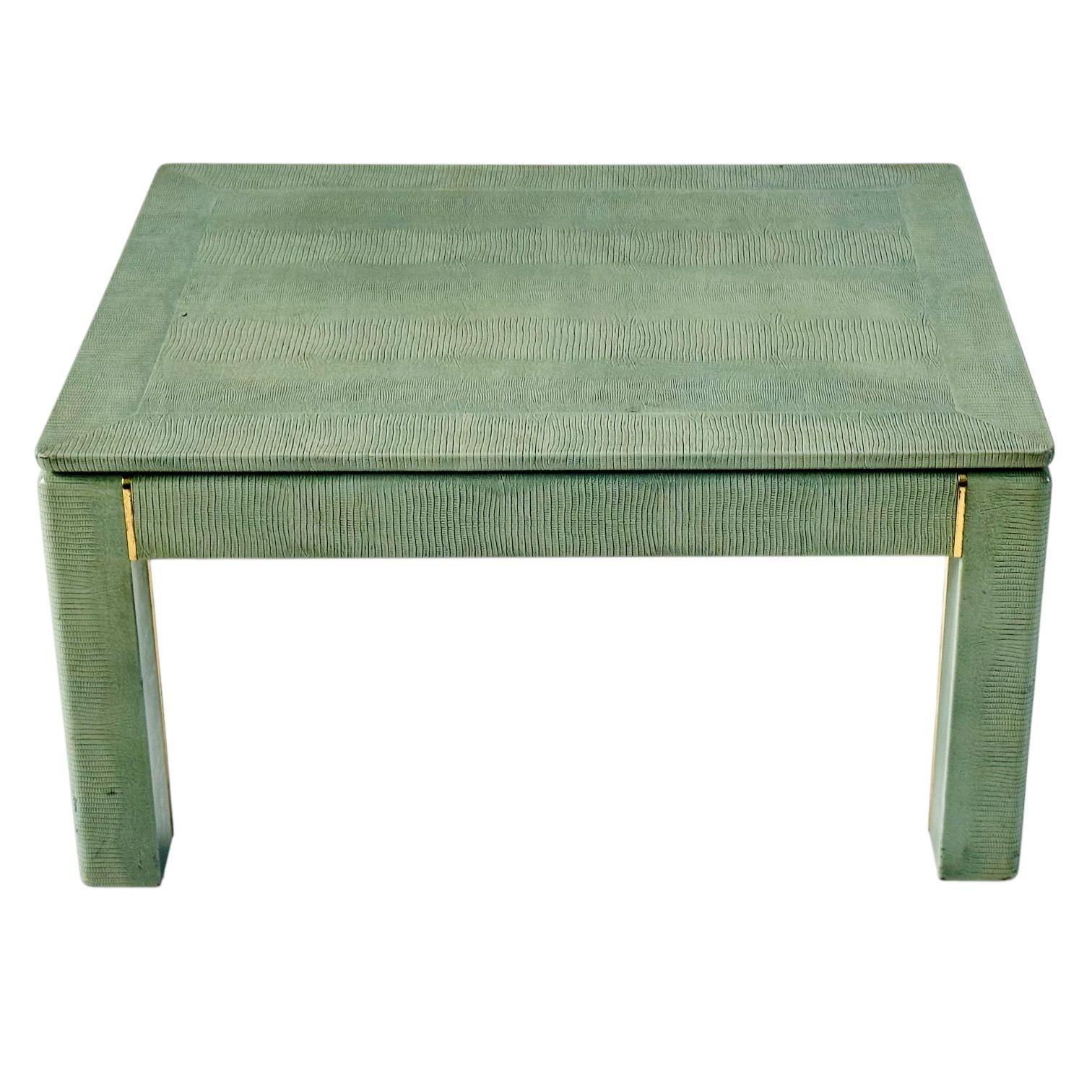 Karl Springer Lizard Skin Side/End Table with Brass Trim, 1970’s.
Measures 17.25” tall 32” wide 24” deep