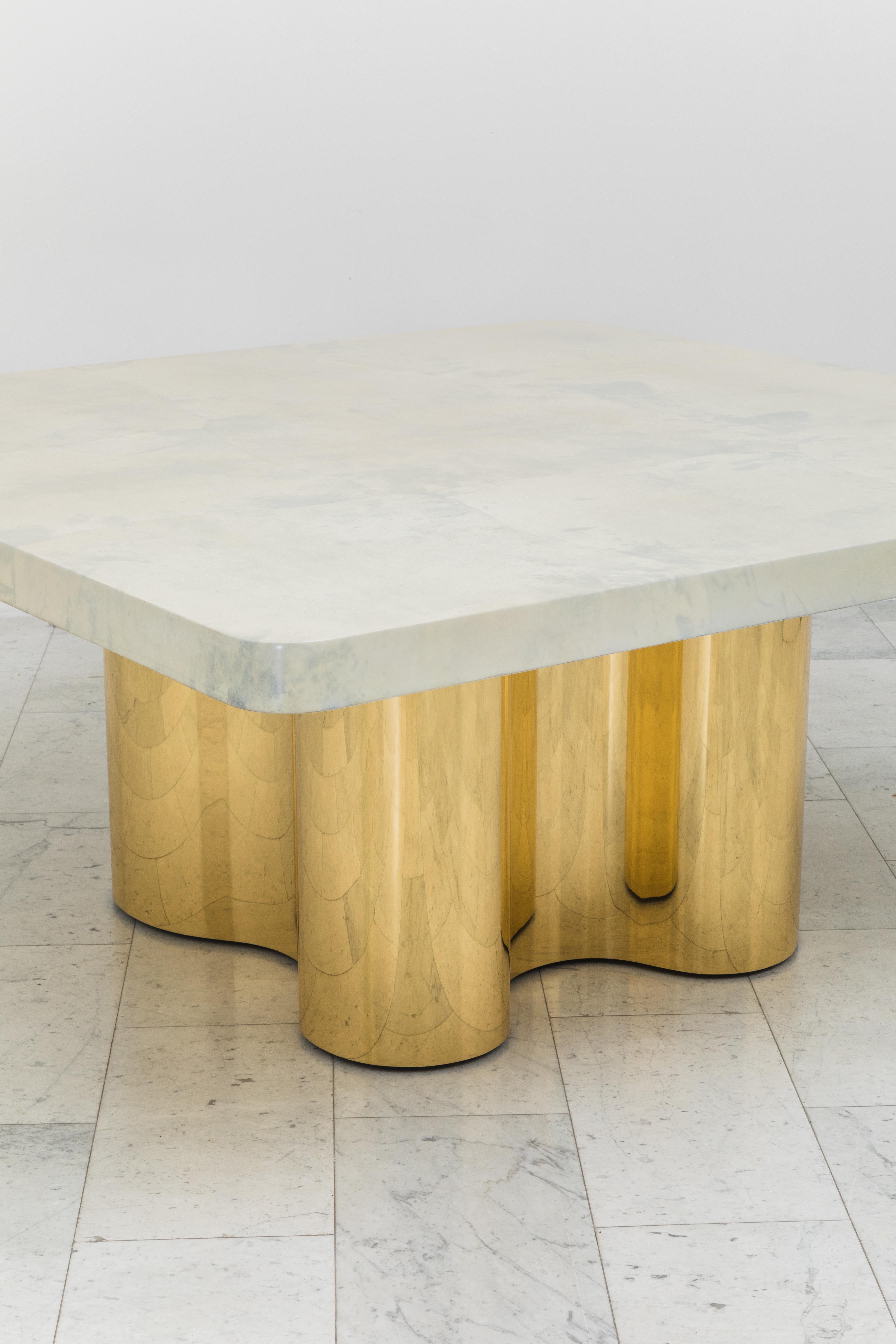 He Freeform dining table with custom goatskin top combines Springer’s Classic 1970s Freeform Table design with a custom lacquered goatskin top. Sleek and elegant, the mirror-polished bronze table bases are set on hidden, recessed casters so they may