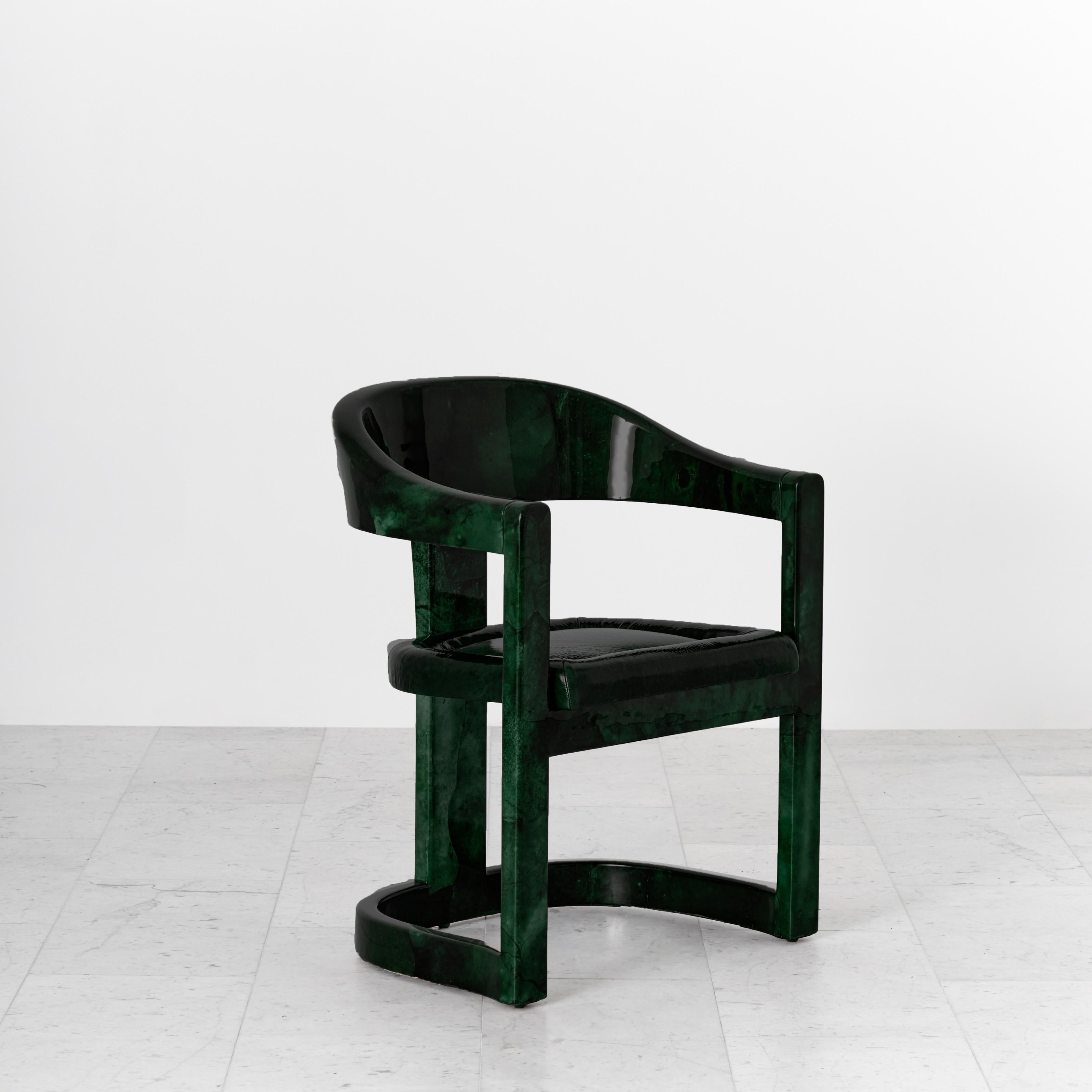 An iconic form by Karl Springer, the Onassis chairs, originally commission by Jacquelyn Kennedy Onassis, feature a barrel back and semi–circular arm rests. The chairs can be commissioned in a variety of woods, finishes, including a range of colored