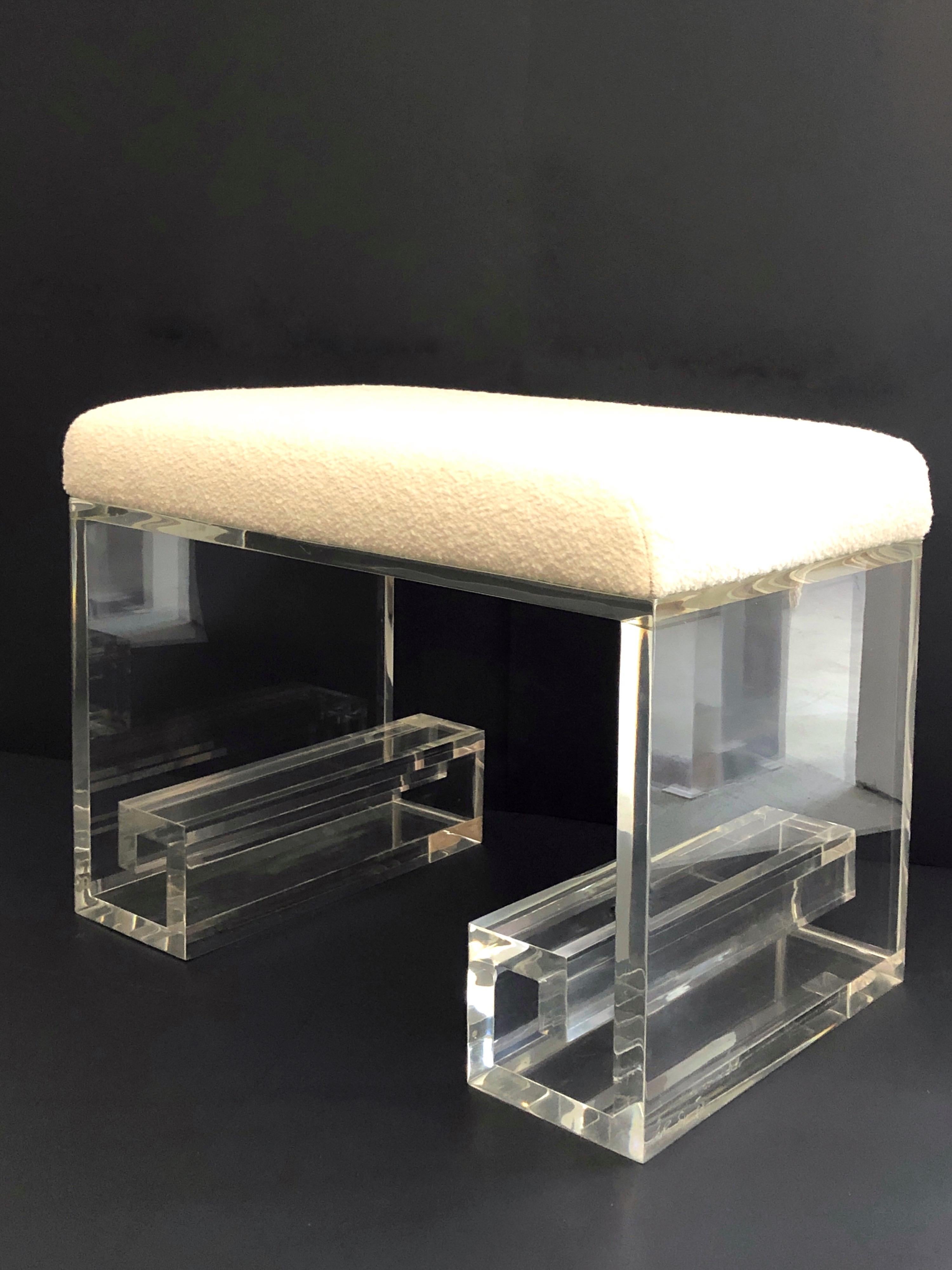 A Lucite stool by Karl Springer. Signed on bottom edge. New boucle upholstery.