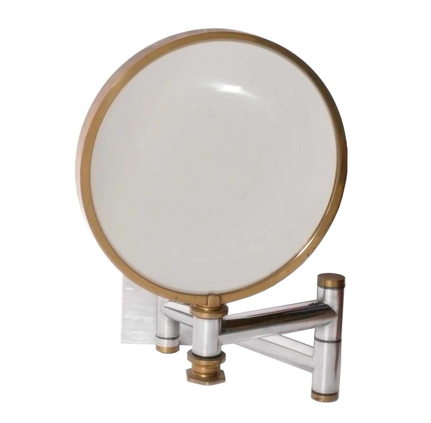 Elegant Chrome and Brass Magnifying Mirror, designed by Karl Springer, American, circa 1980s. Rare, hard to find Springer design. The only other two examples online are priced at $8500 and $7500. The diameter of the mirror is 13.5