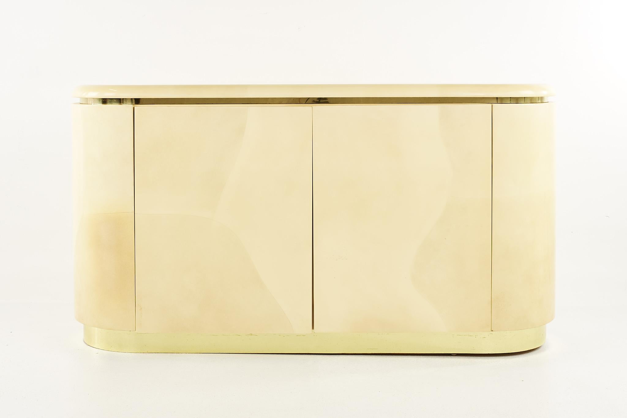 Karl Springer mid century brass and lacquered goat skin credenza

This credenza measures: 59 wide x 18 deep x 31.75 inches high

All pieces of furniture can be had in what we call restored vintage condition. That means the piece is restored upon