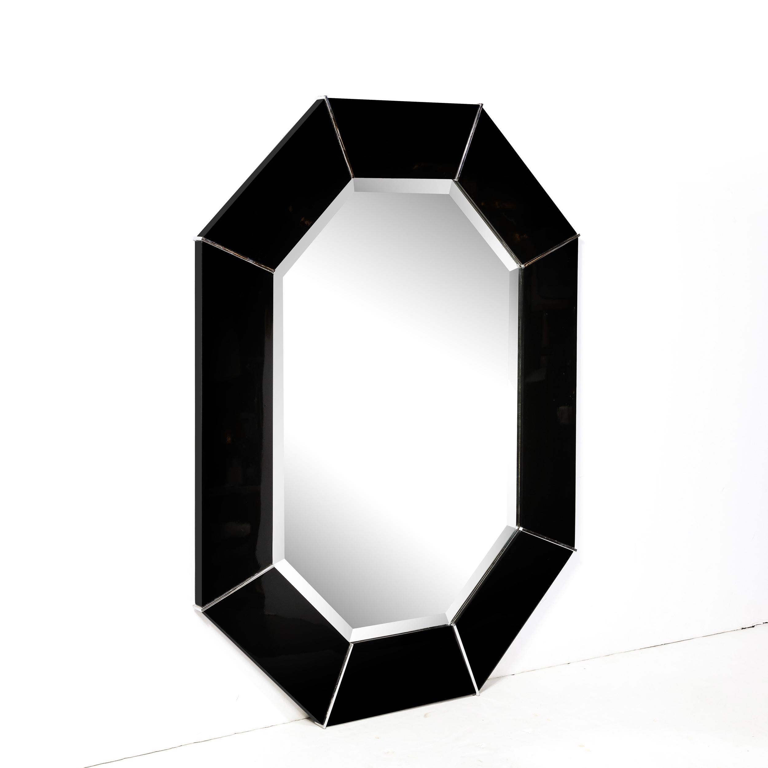 This gorgeous and important Mid-Century Modern black lacquered mirror was realized by Karl Springer- one of the most esteemed designers of the 20th century. Springer was known for reviving Classic Art Deco designs with bold proportions and exotic