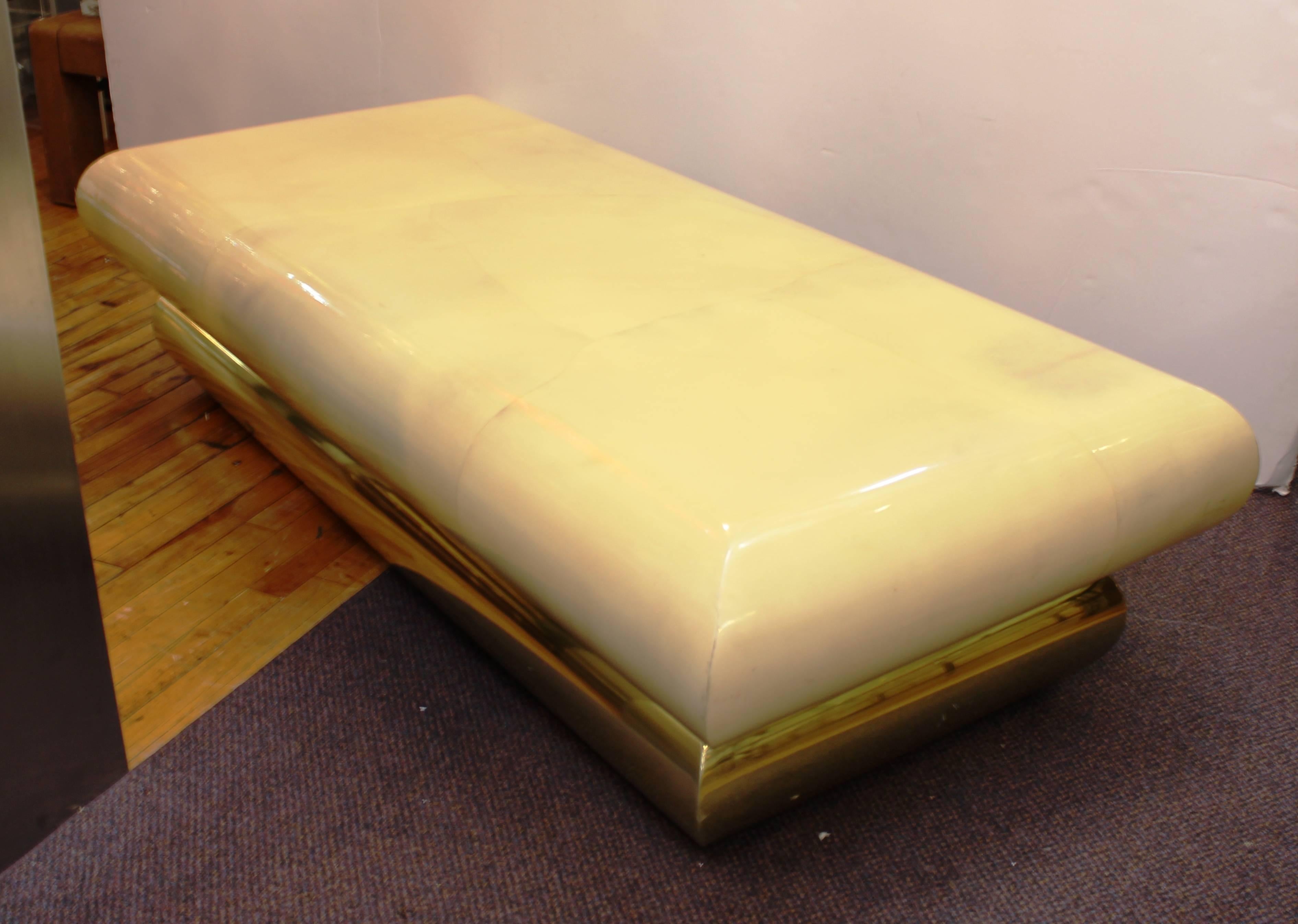 A Mid-Century Modern goatskin and brass cocktail or coffee table. The piece is in good vintage condition with age appropriate wear. Some minor scuffing along the edges.