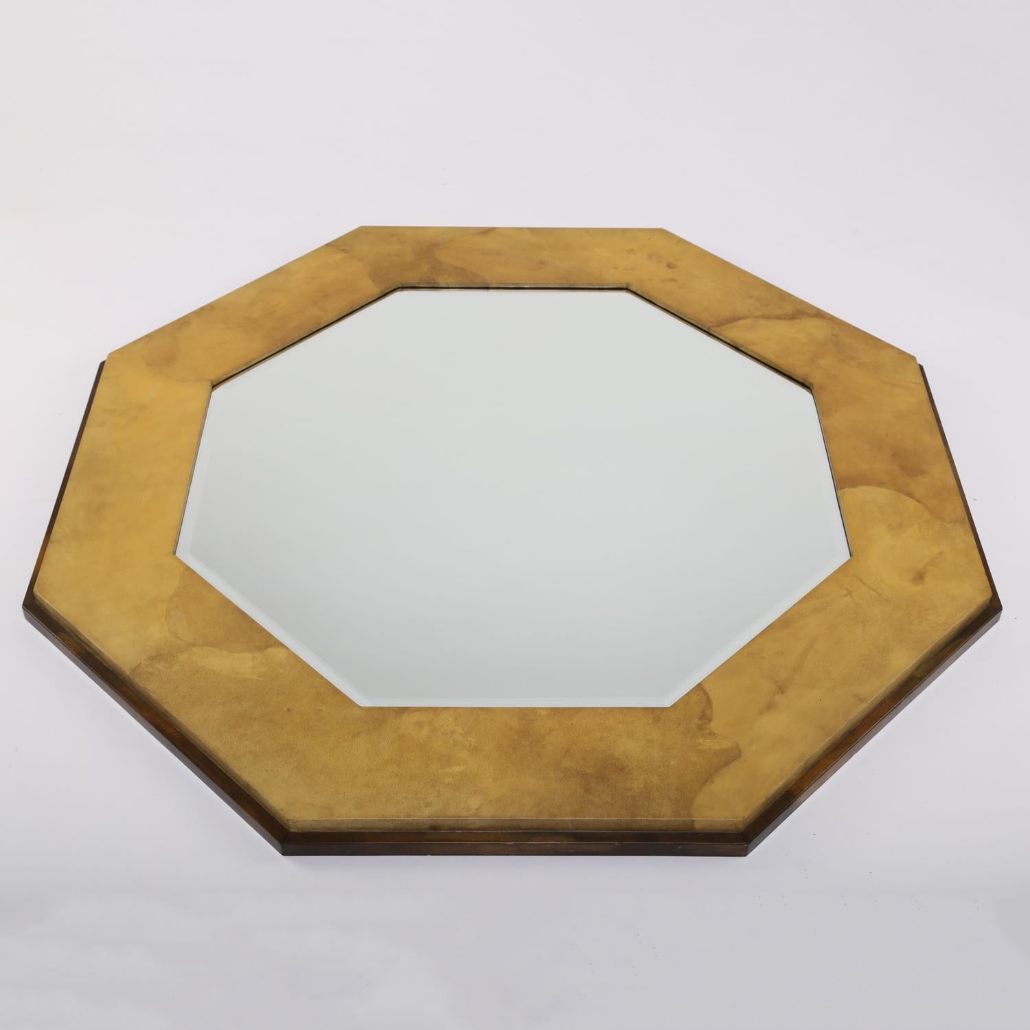 Wall hanging mirror, octagonal with lacquered light goatskin in front of darker lacquered goatskin edge, with beveled mirror inside, by Karl Springer, American, 1970’s. The combination of light and dark lacquered goatskin is beautiful.