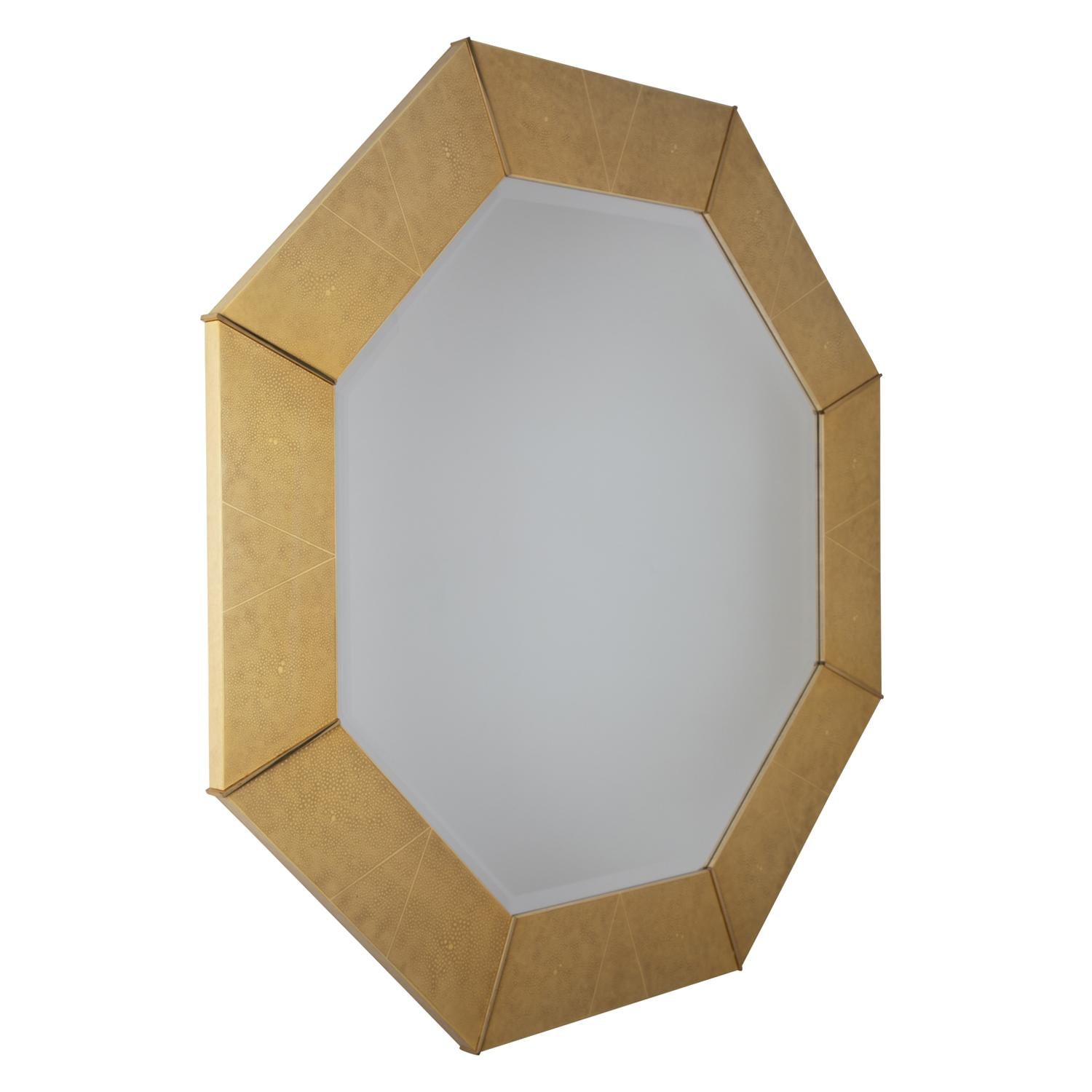 Exceptional wall hanging mirror, octagonal with artisan shagreen lacquer with brass accents, by Karl Springer, American 1980's. Mirror is beveled.

Reference:
Karl Springer LTD paper catalog published in the 1970’s shows an image of this model on