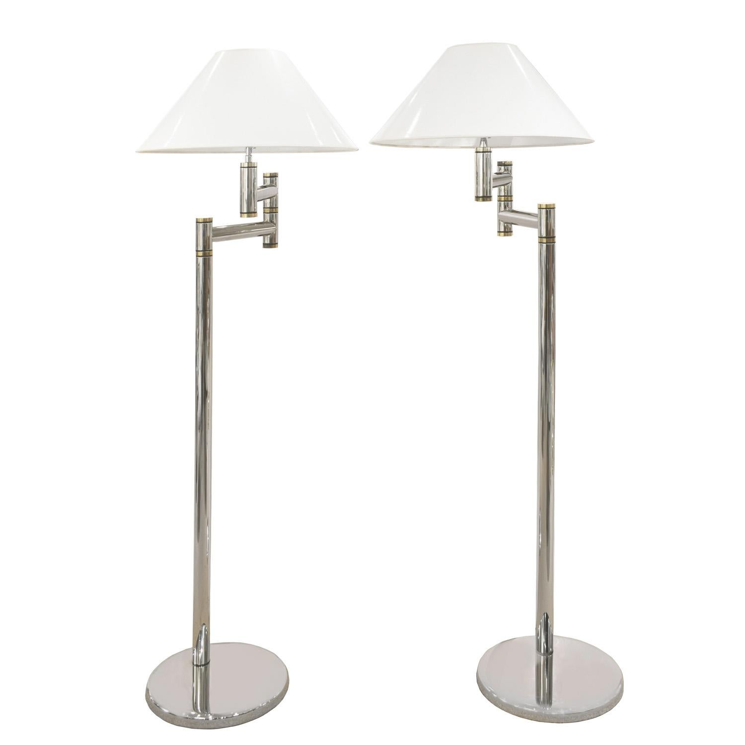 Pair of meticulously crafted swing-arm floor lamps in polished chrome and brass by Karl Springer, American 1980's. The quality of construction of these lamps is superb. These have been cleaned and polished and newly rewired by Lobel Modern.

Arm