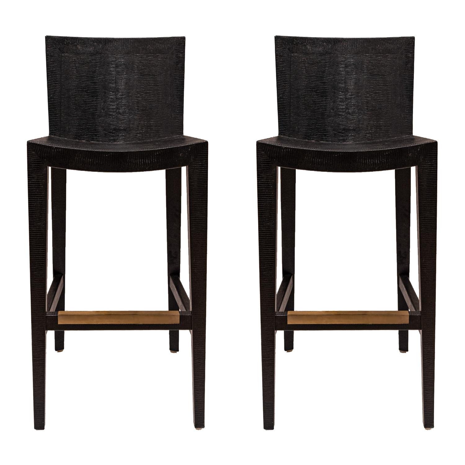 Pair of “JMF Barstools” in black embossed lizard leather with brass footrests by Karl Springer, American 1986 (signed and dated on bottom “Karl Springer 1986”). The embossed leather is very luxurious and these are fine examples of Springer’s superb