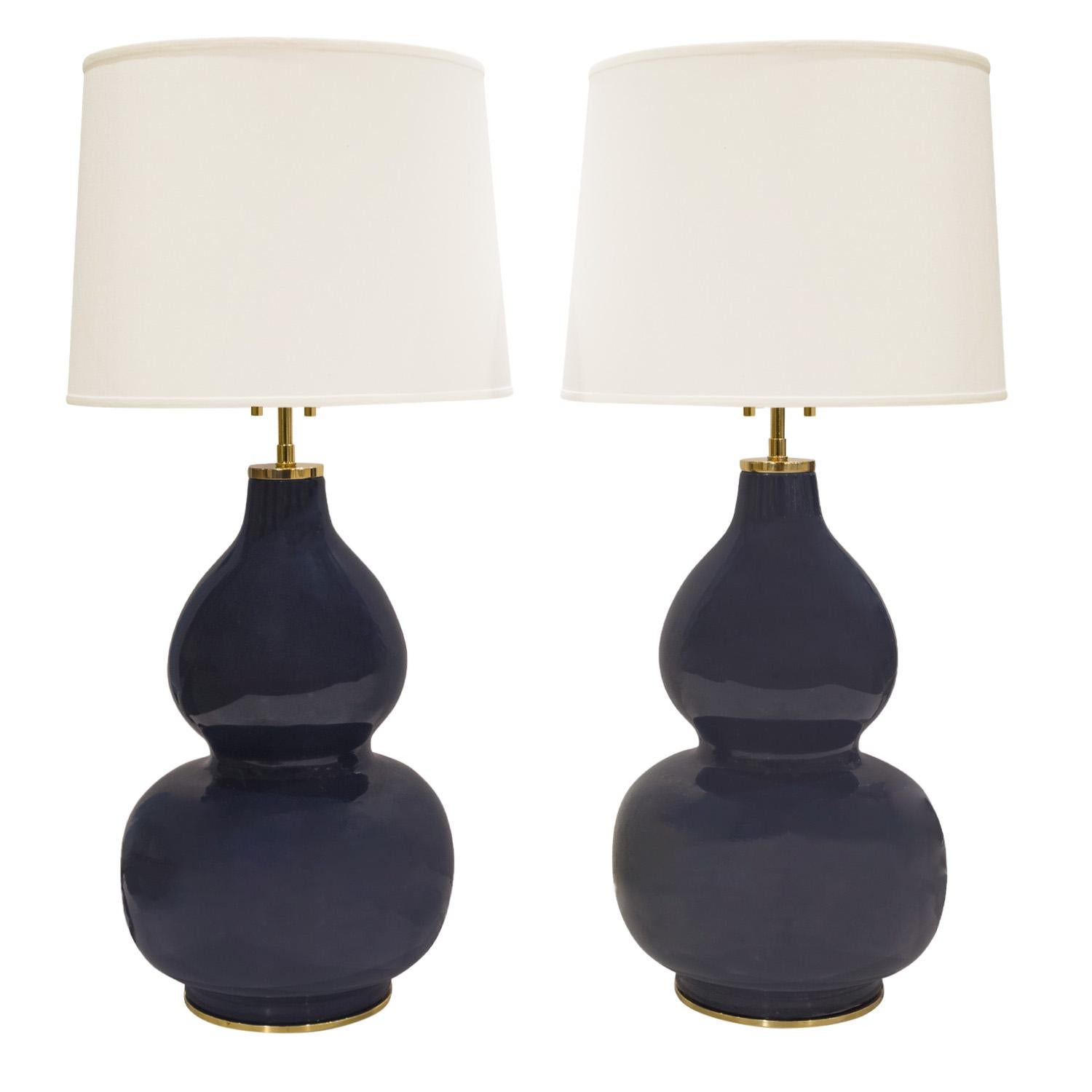 Pair of artisan “Mandarin Table Lamps”, ceramic double gourd forms with deep blue mirror glaze, with polished brass bases and hardware by Karl Springer American 1980's. These lamps are exquisite. Brass has been polished and lacquered. Newly rewired