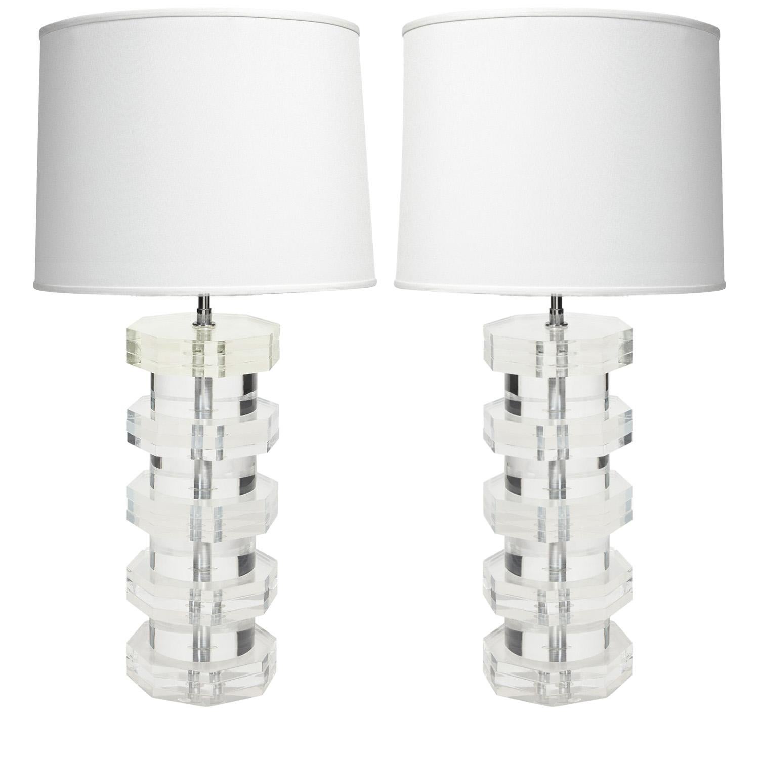 Pair of solid lucite table lamps with octagonal sections separated by cylindrical sections with chrome hardware by Karl Springer, American 1970's. As with all Springer’s pieces, these are beautifully made.  

Shade 16 inch diameter x 12 inches high
