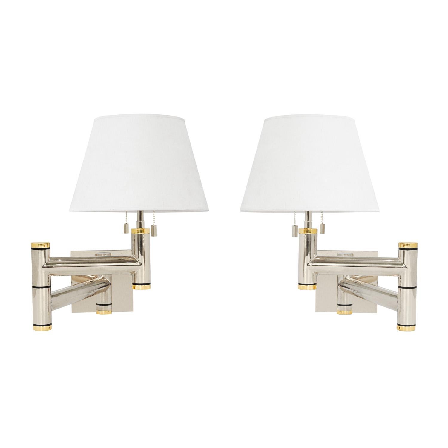 Pair of beautifully made swing-arm wall lamps in polished chrome and brass, each with 2 bulbs, by Karl Springer, American 1980's. Each comes with a back mounting plate. The craftsmanship on these is off the charts. These have been cleaned, polished