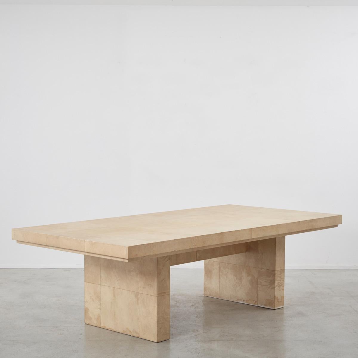 This parchment table attributed to Karl Springer, is monolithic with grand proportions, seating up to 12. A designer of luxury furniture and objects, Springer (born Berlin, 1931) cut his cloth as a bookbinder and window dresser before emigrating to