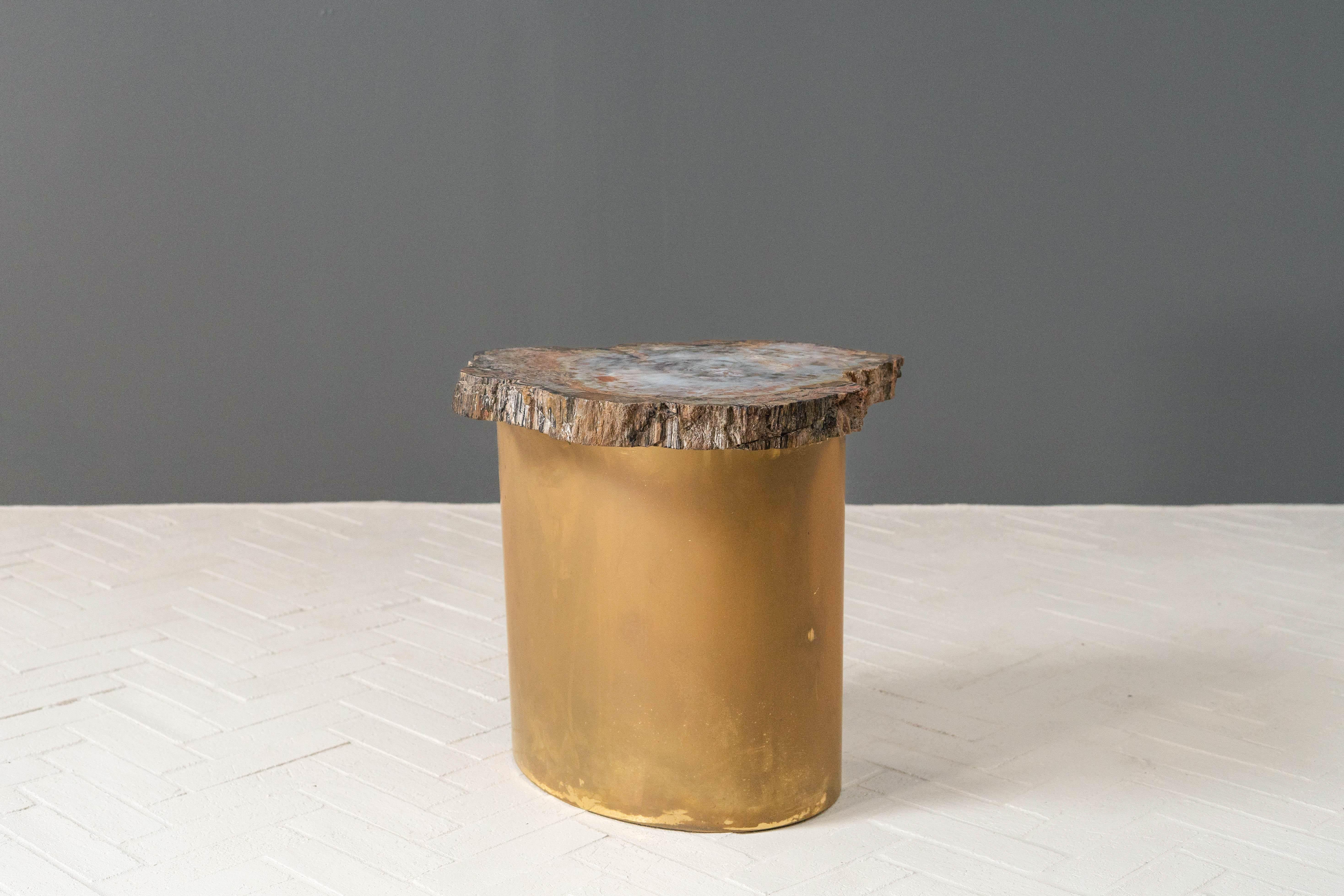 USA, ca. 1970s. A rare and quite chic side or accent table by Karl Springer (1931-1991). Features curved solid brass base with asymmetrical top fashioned from a large specimen of petrified wood sourced in Arizona. A striking blend of textures and
