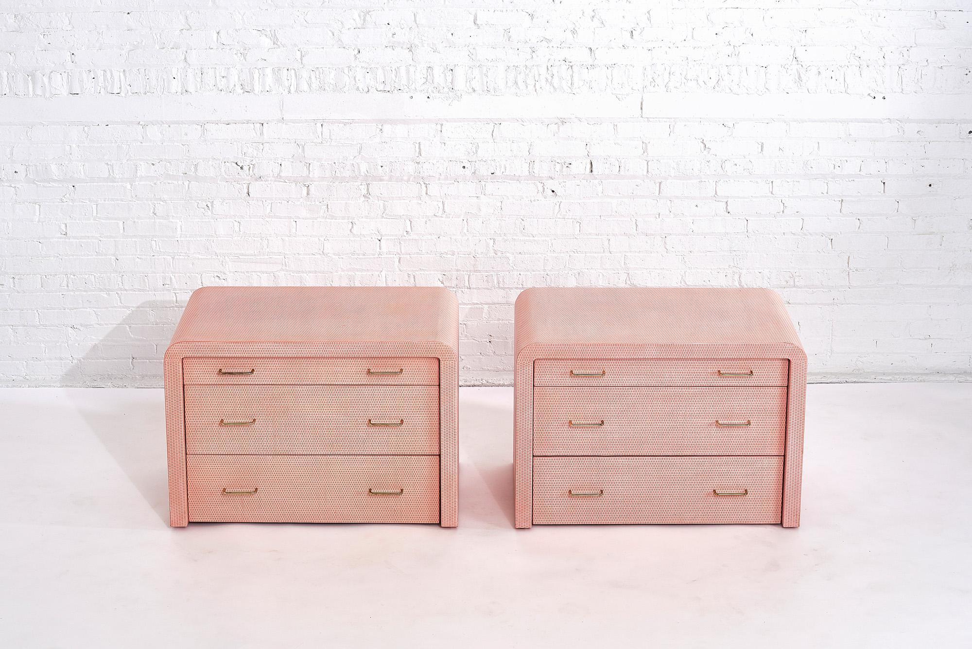 Karl Springer pink lacquered grass cloth pair dressers, nightstands with brass hardware, circa 1970s.