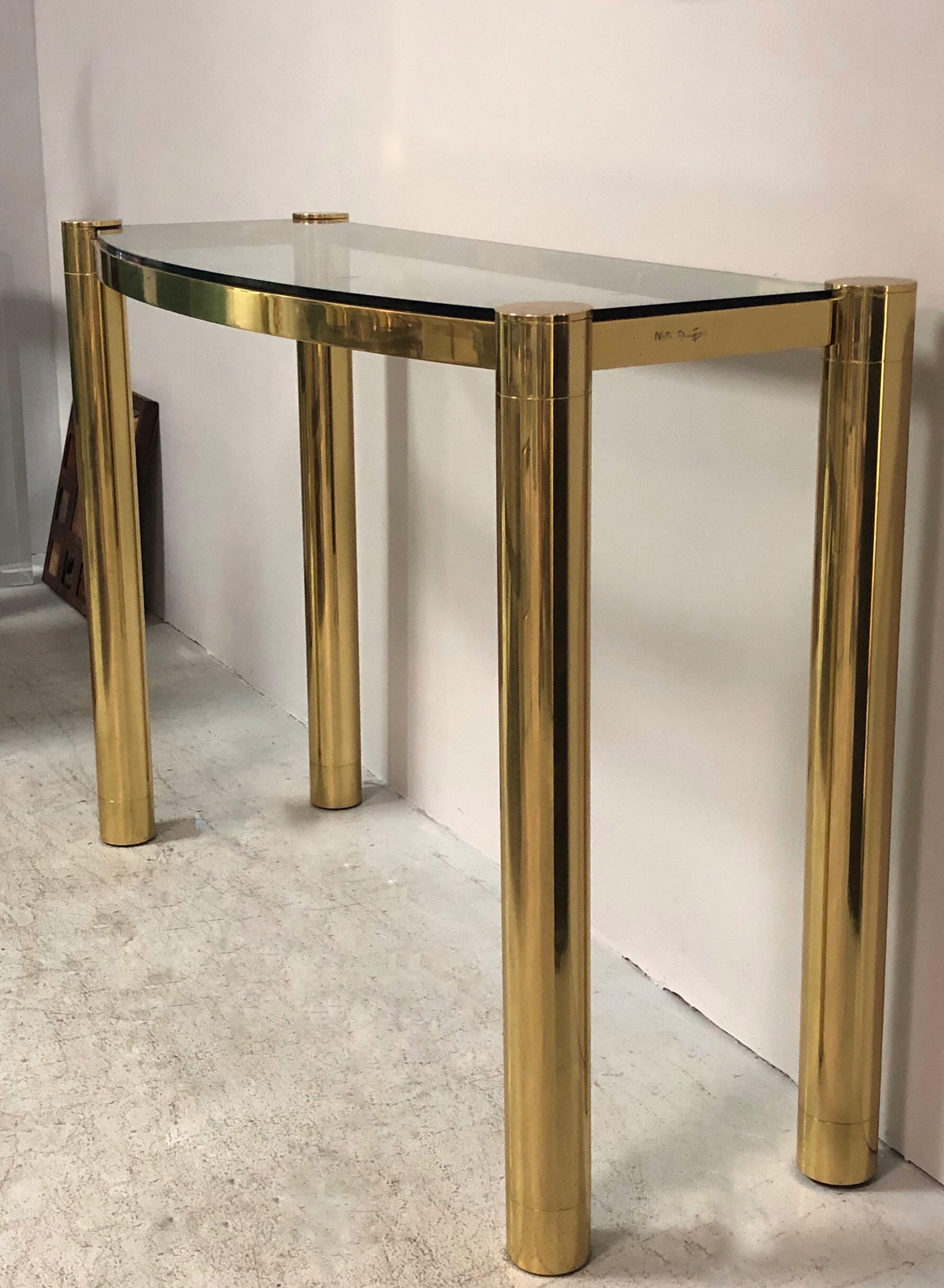 A solid bronze console with glass top by Karl Springer. Exquisitely crafted. Signed on edge. The design is subtle with quite lines that are complemented by the richness of the chosen material.