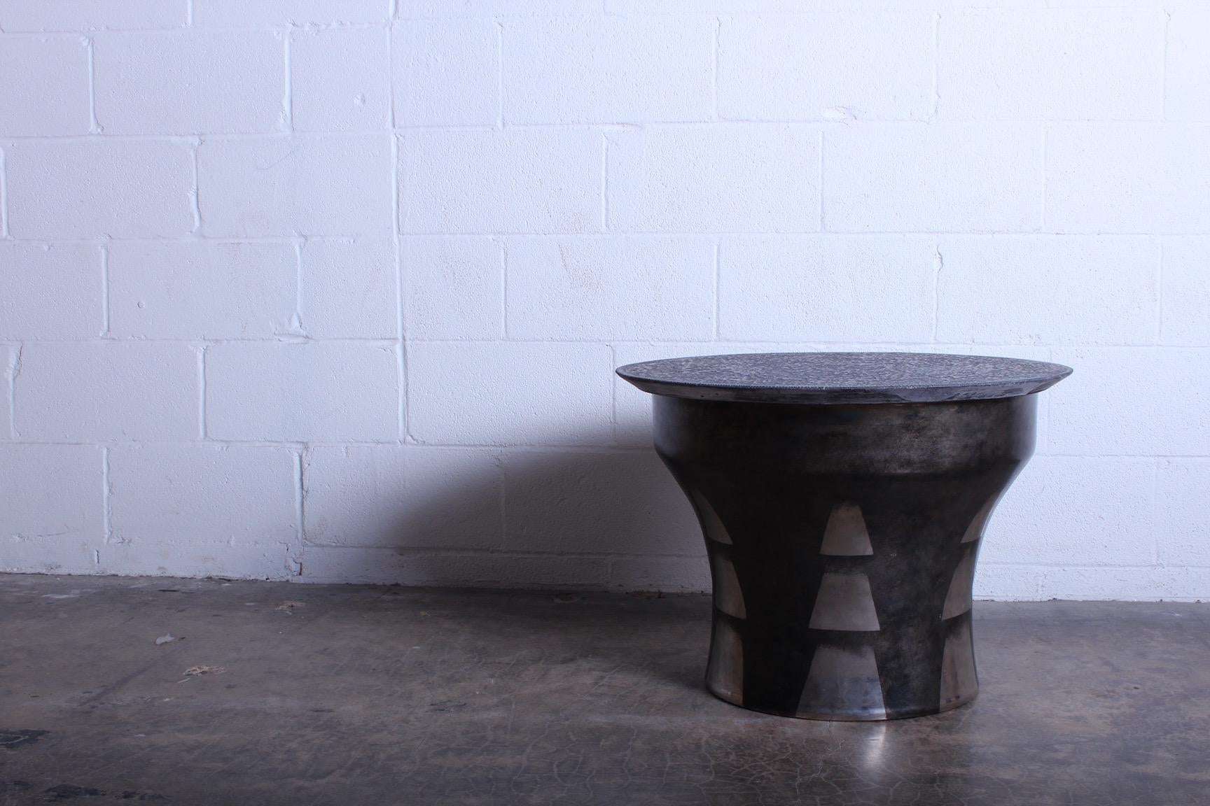 A rare rain-drum table with etched granite top. Designed by Karl Springer.
