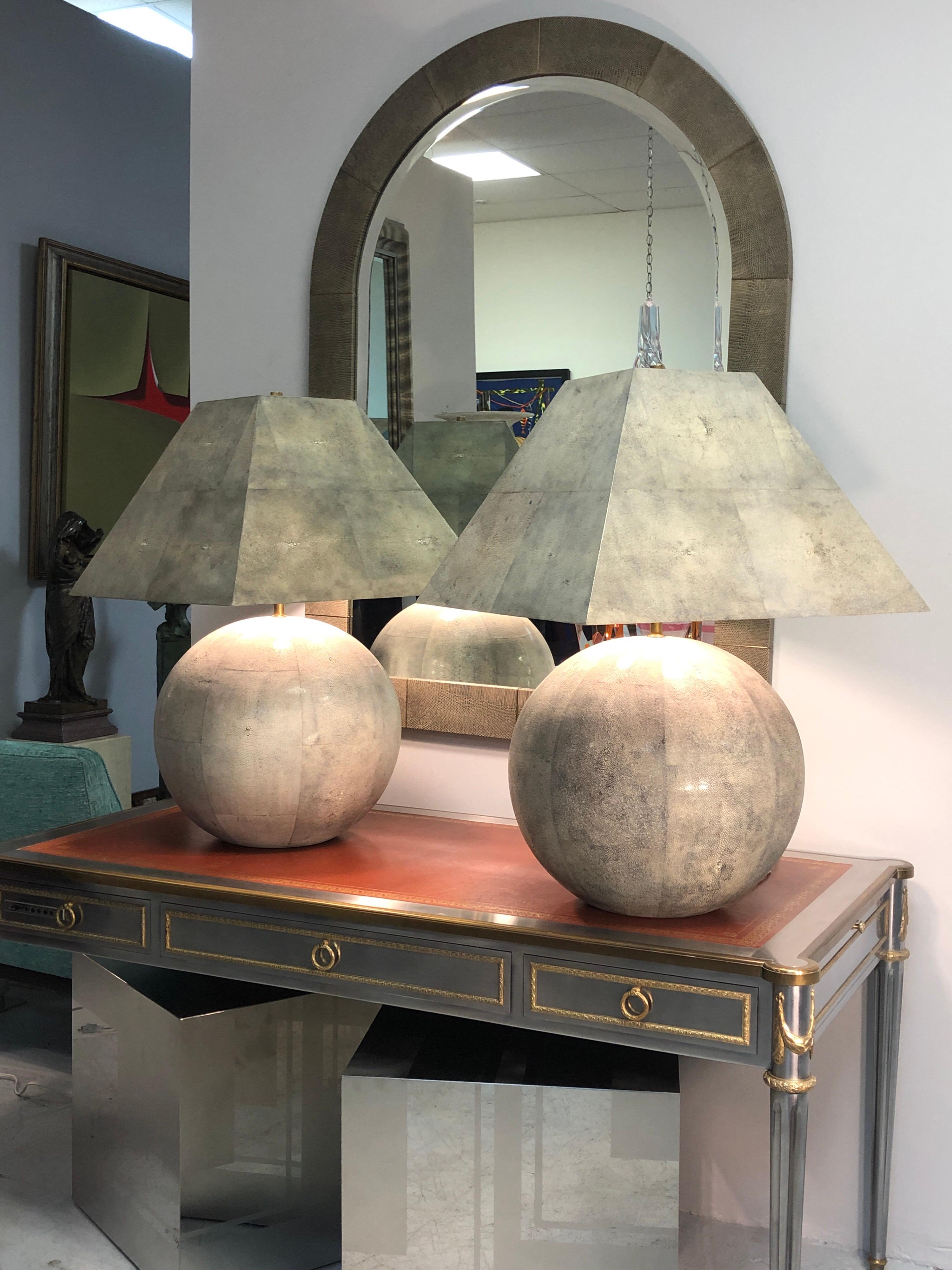 A pair of exquisite lamps by Karl Springer. The large spheres are solid wood meticulously covered in shagreen, the Pyramid shades are also wood covered in shagreen. Reportedly just a handful of these lamps were created making this pair an extremely
