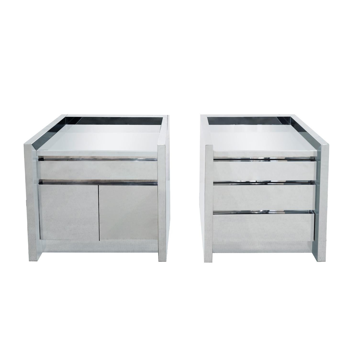 Pair of rare and exceptional bedside tables in polished stainless steel with glass mirror tops, one with 1 drawer above 2 doors and one with 3 drawers by Karl Springer American 1980s. This series in stainless steel is among Springer’s finest.