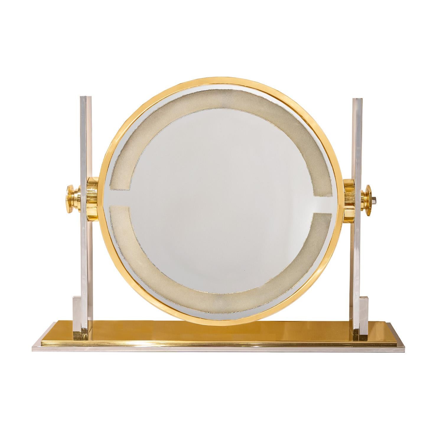 Meticulously crafted extra large adjustable illuminating magnifying mirror in polished steel and brass by Karl Springer, American 1980's. This mirror has been completely restored - light has been replaced with a LED component that will last a very