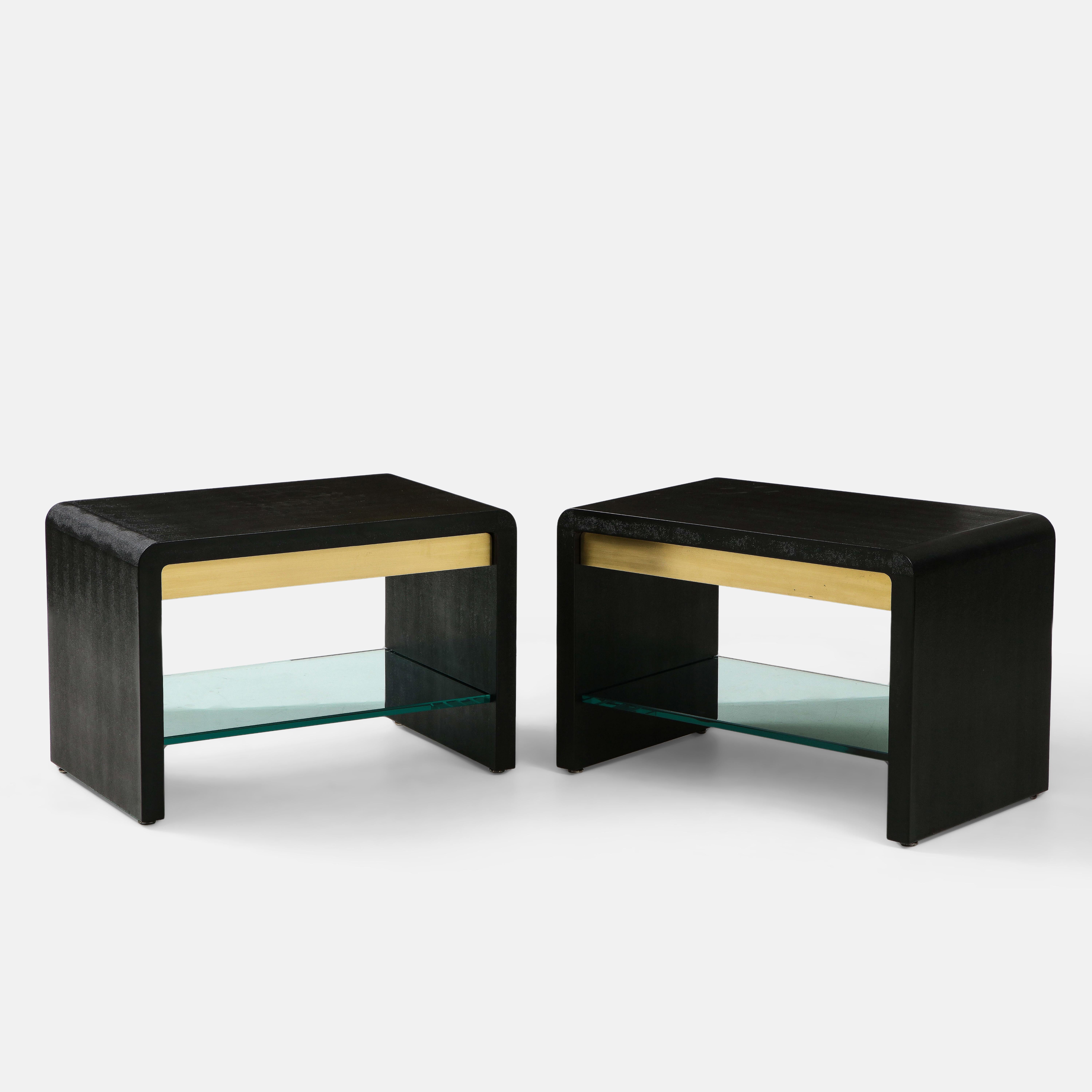 Karl Springer rare pair of large waterfall side or end tables covered in black lizard embossed leather with brass drawers and original thick glass shelves below. These exquisite pair of side tables are the larger scaled model of this side table and