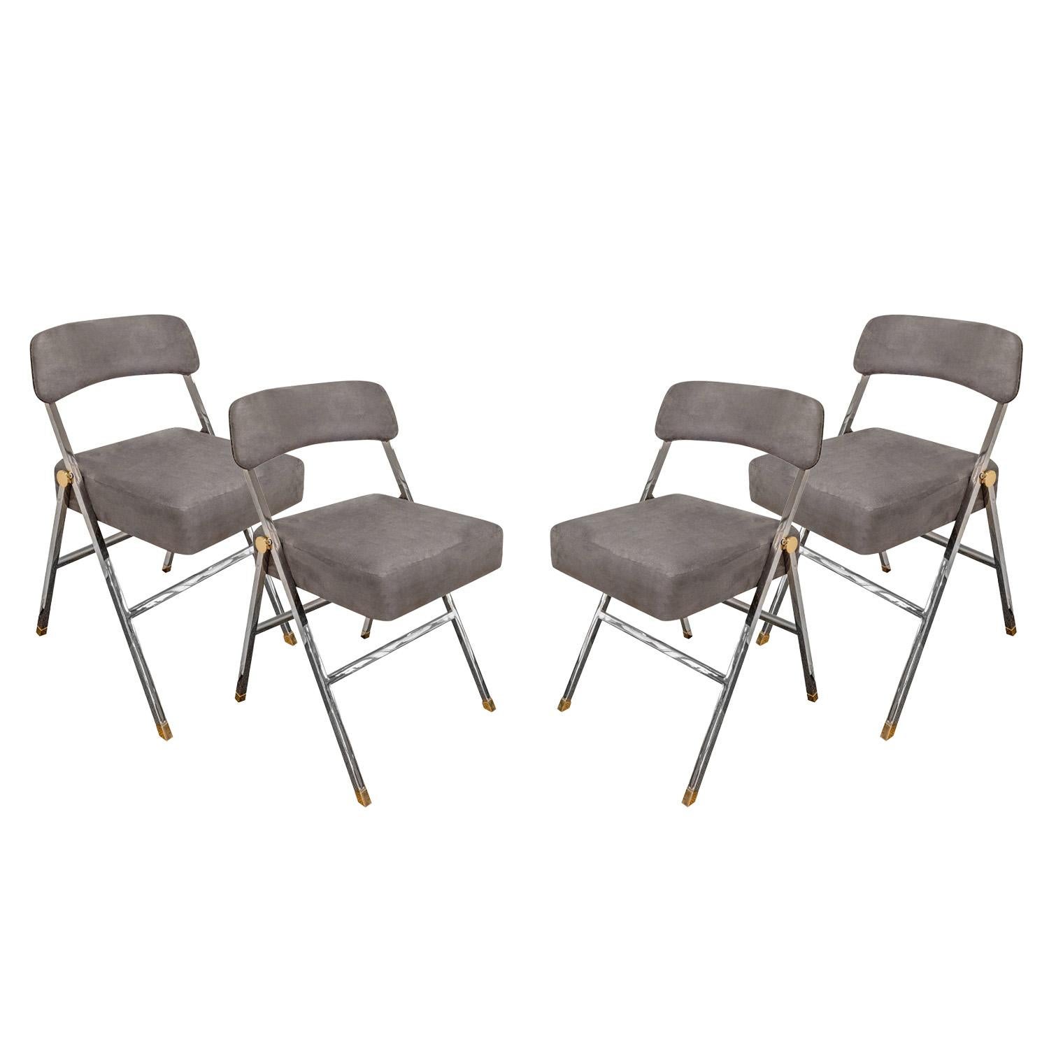 Rare set of 4 folding chairs, beautifully crafted in polished brass and chrome with upholstered seats and backs, by Karl Springer, American 1980's.  Metal has been professionally cleaned and polished, chairs have been newly reupholstered in gray