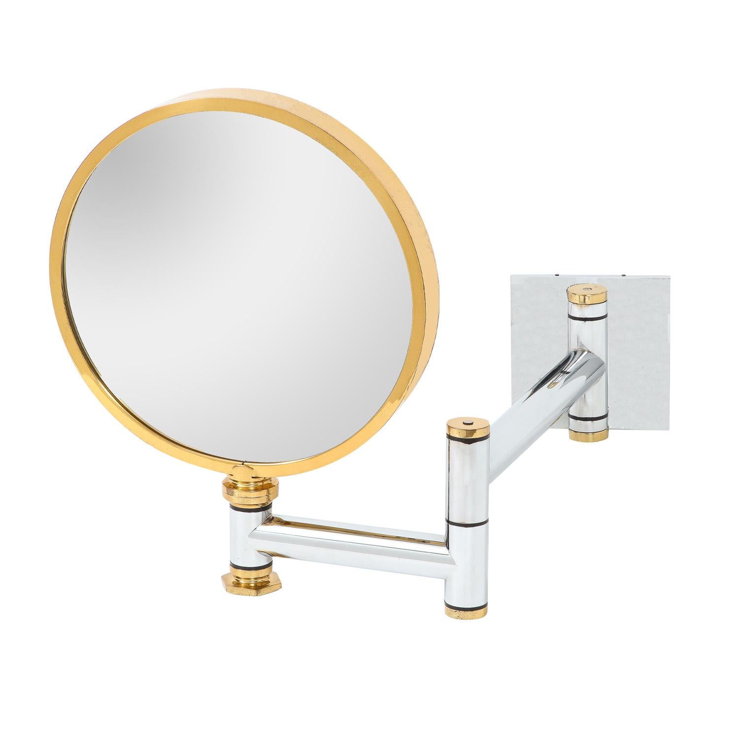 Rare wall-mount retractable finely crafted make up/shaving mirror in heavy gauge polished chrome and brass by Karl Springer, American 1980's. The craftsmanship of this mirror is off the charts. The combination of metal is very chic.

Closed