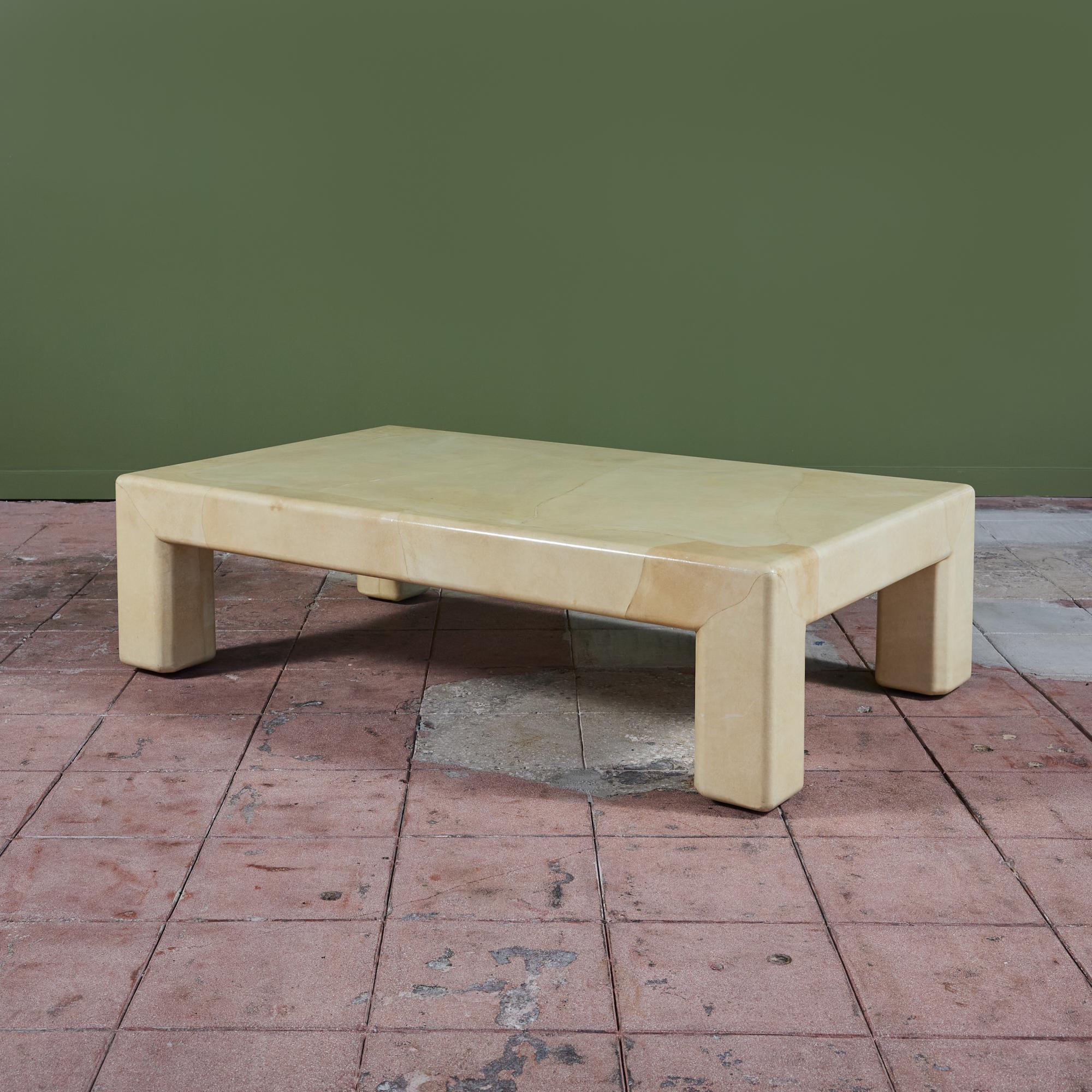 A postmodern rectangular coffee table by Karl Springer, c.1980s, USA. This coffee table features a lacquered goatskin with a smooth finish and soft edges. The table is a natural beige and cream color throughout.

Dimensions
60” width x 36” depth x