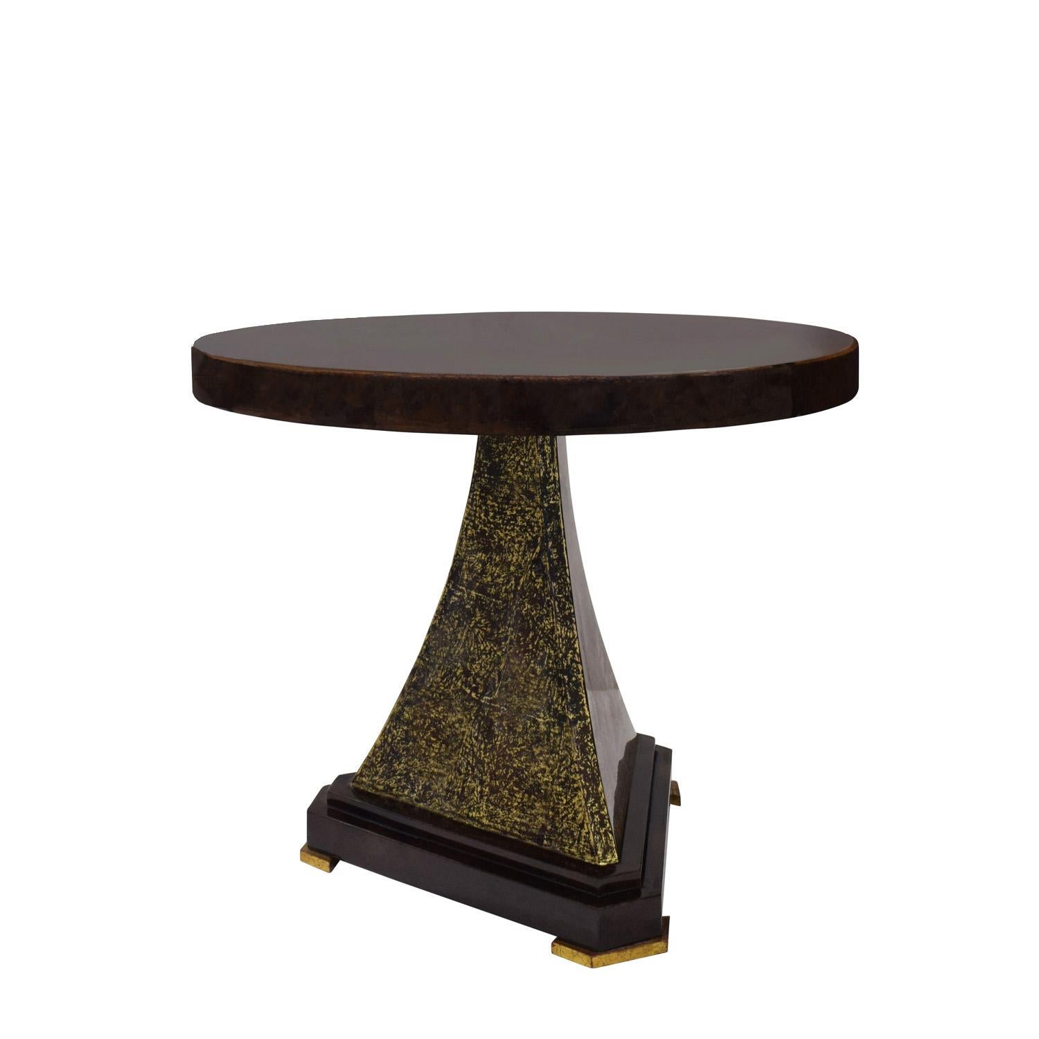 “Regency Side Table” in rich chocolate brown lacquered goatskin with pie-cut top, gold leaf overlay on pedestal section of base, and gilded feet by Karl Springer, American 1993. This is a luxuriously finished Springer piece and a unique work of