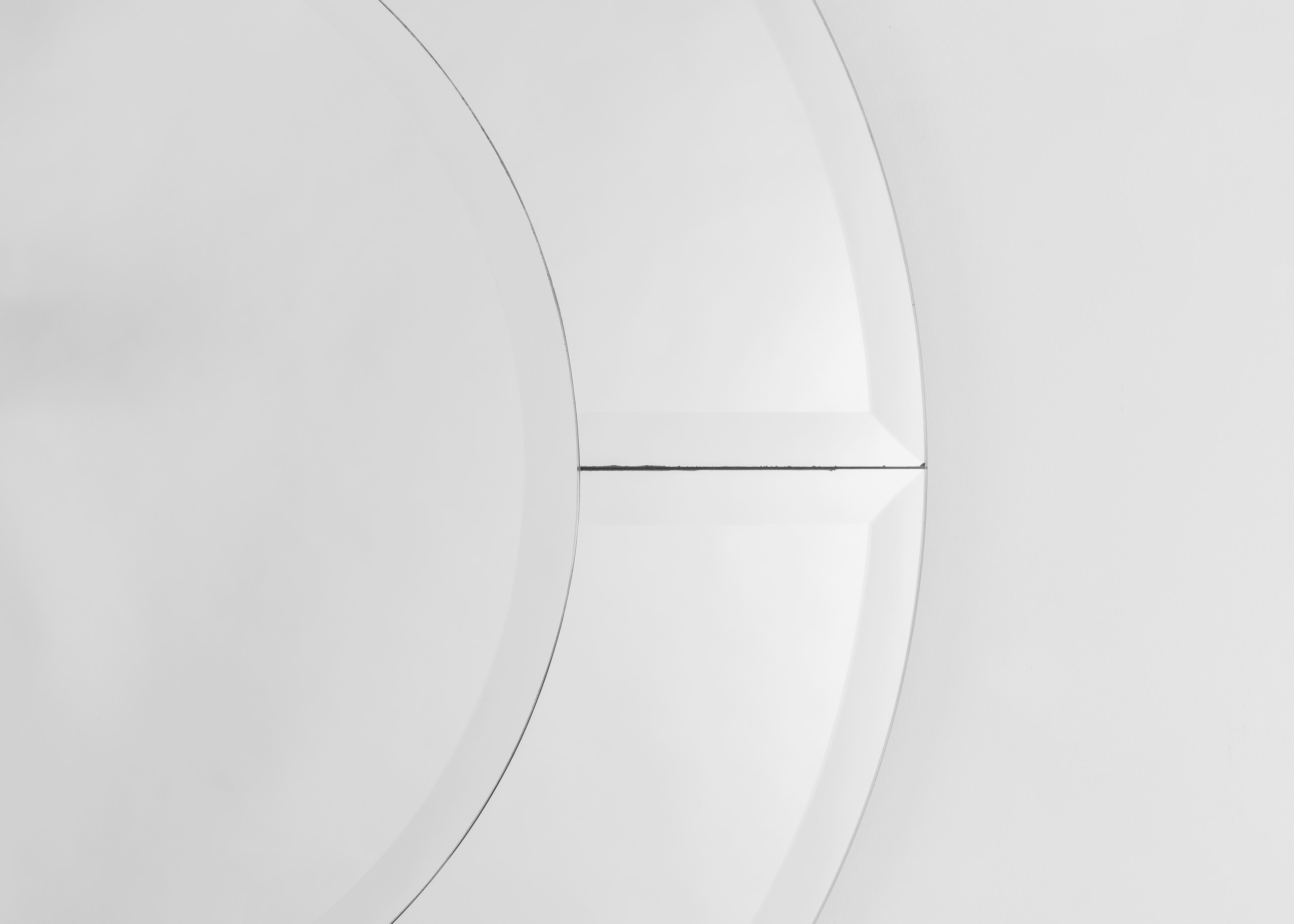 Broken up into five pieces by borders of beautifully beveled glass, Karl Springer's Saturn mirror, designed in the mid-1980s, possesses a symmetry and presence befitting its name.

Bears a signature tag.