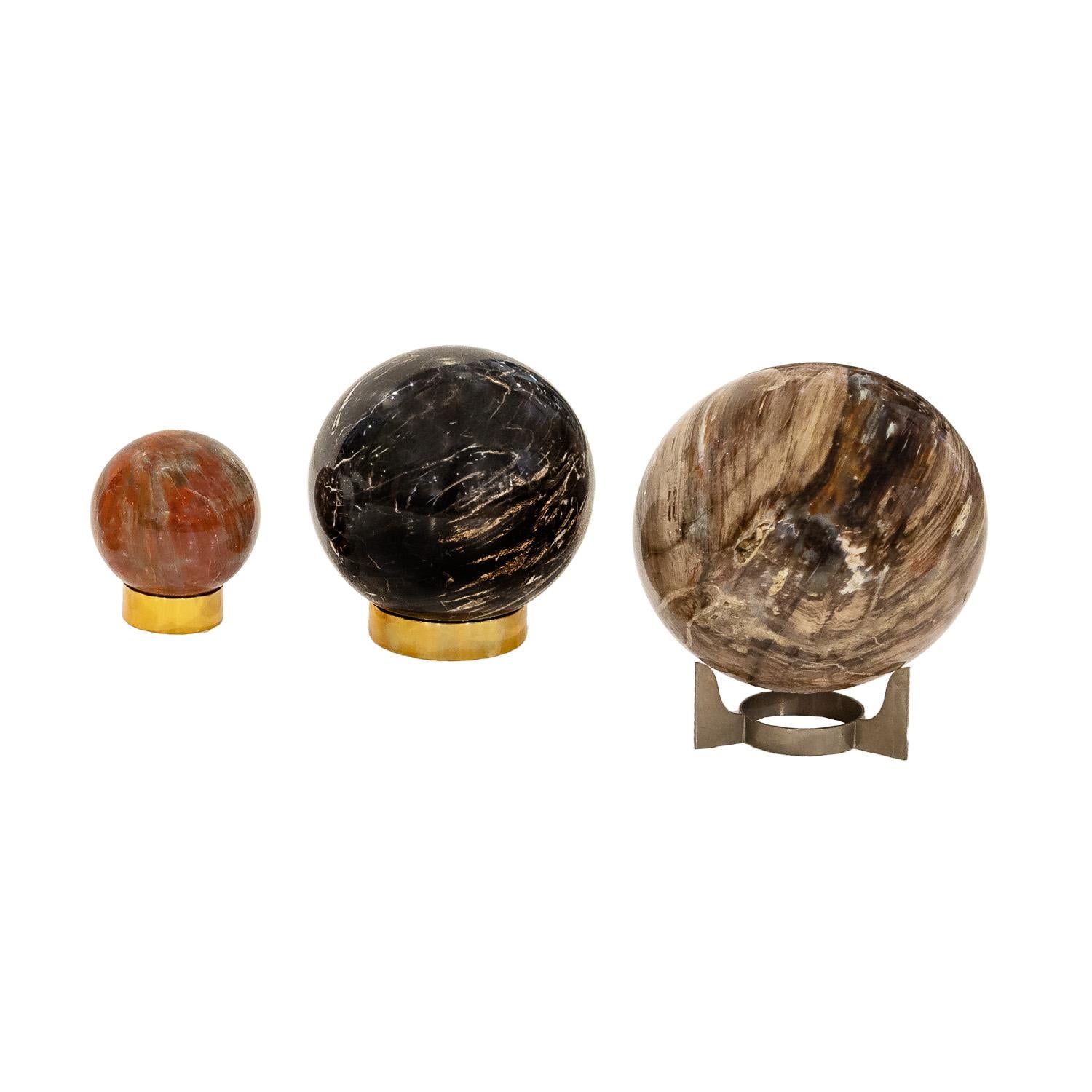 Set of 3 polished petrified wood orbs on custom metal bases by Karl Springer, American 1980's (retain original labels from the 1980s showing the original prices). Stunning materials and superb craftsmanship were the hallmark’s of Karl Springer’s