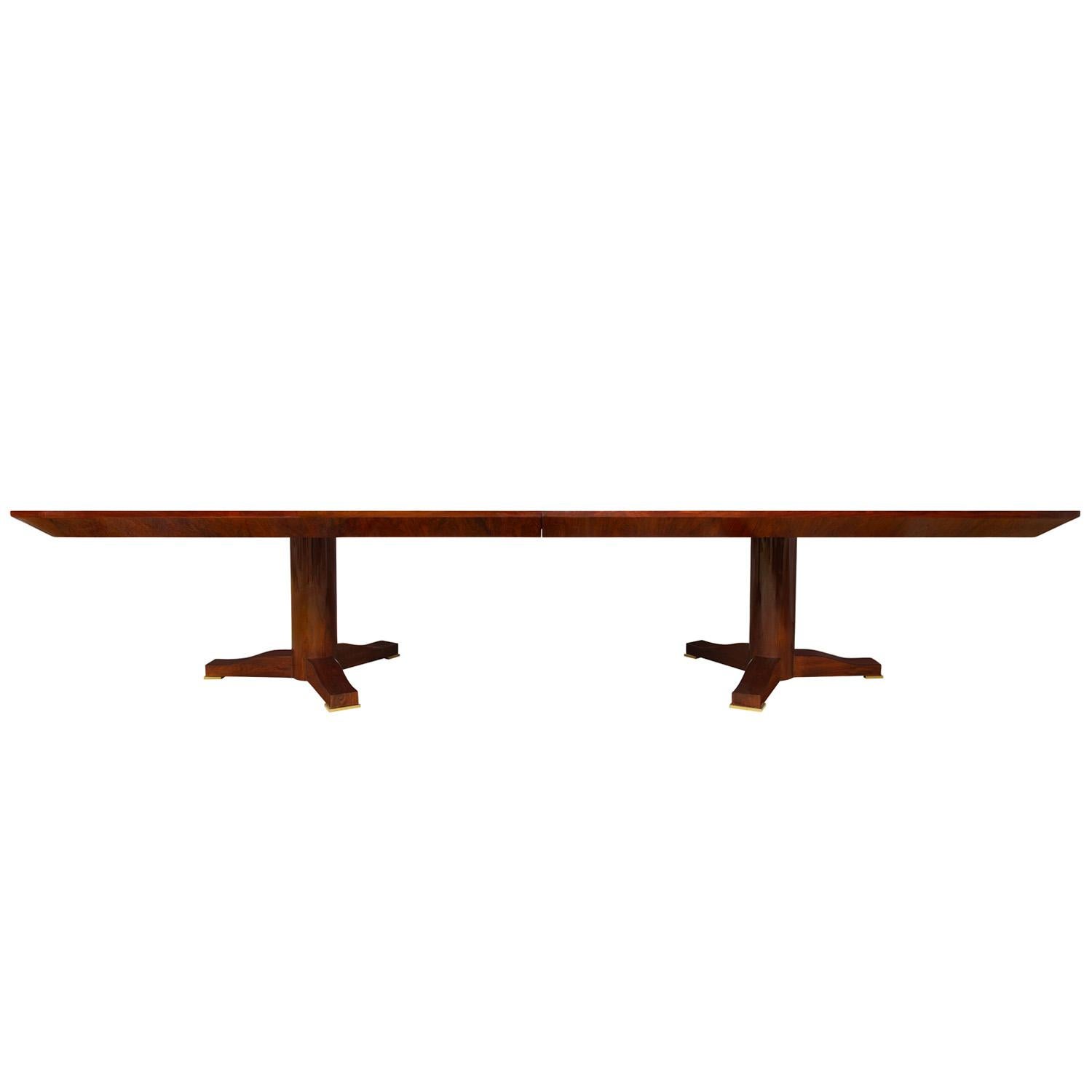 Rare monumental “Regency Extension Dining Table” with 2 matching leaves, top in book-matched Brazilian rosewood with satinwood inlay in high gloss finish with knife edge design, with 2 pedestal bases and solid brass feet by Karl Springer, American