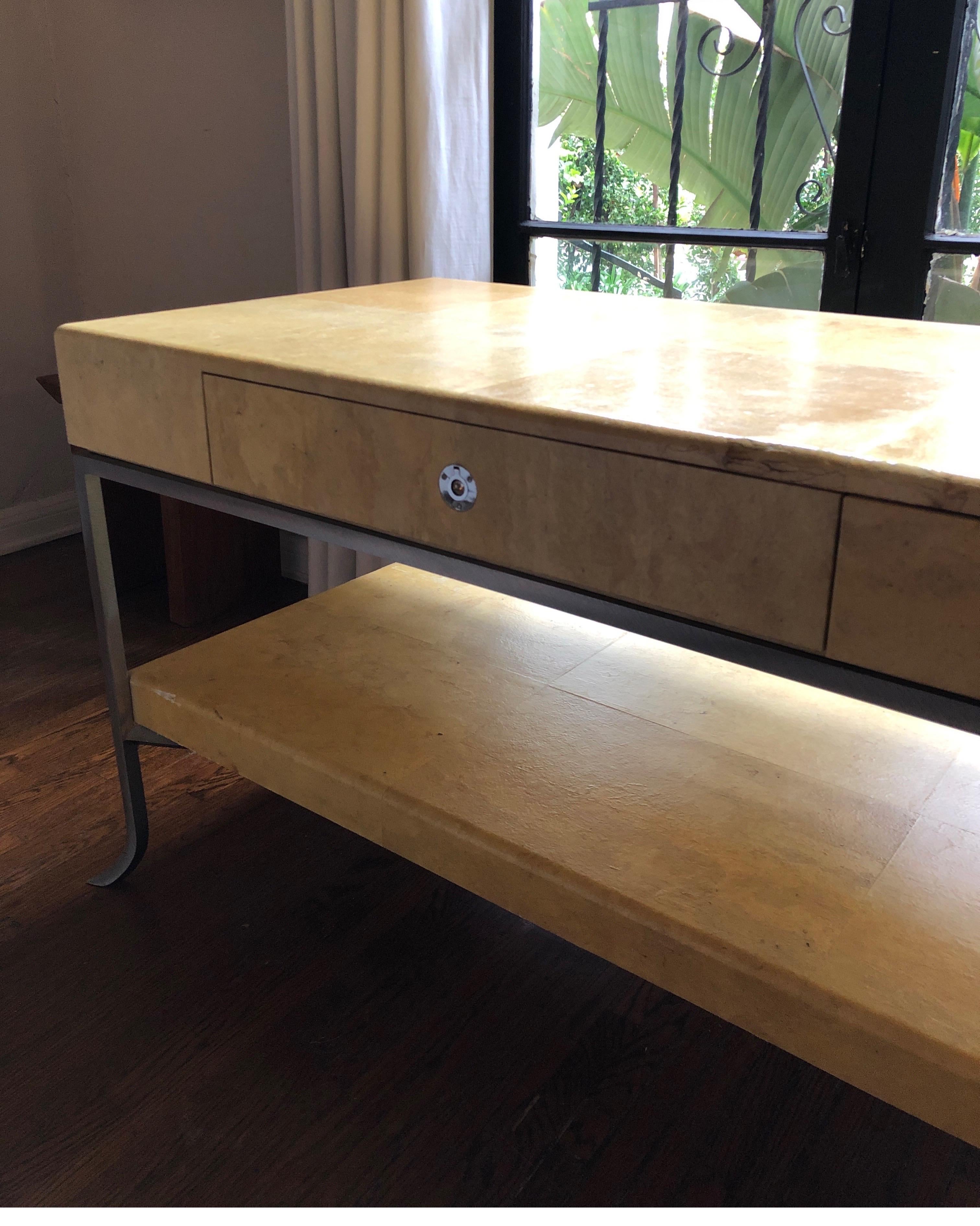 Handsome and unique Art Deco console table. 
Steel base with Parchment wrapped top. Nickel Hardware.
Karl Springer - Samuel Marx - Gio Ponti - Aldo Turo style

Condition consistent with age. Some fading/nicks to parchment and pitting on steel base.
