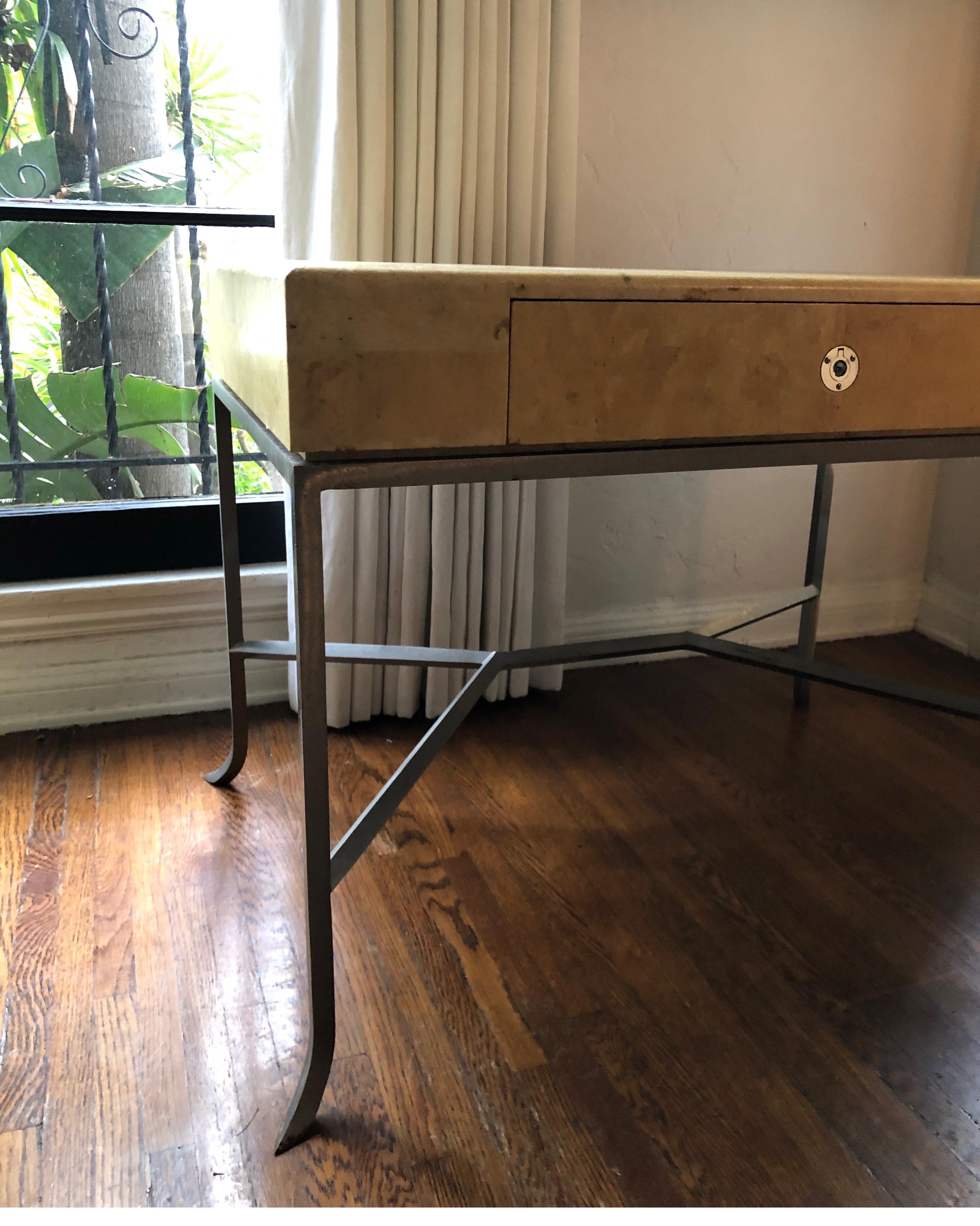 Handsome unique side table.
Art Deco parchment wrapped table with steel/iron base. Nickel hardware.

Condition consistent with age. Does have an area of torn parchment and pitting on steel base. See images.

Karl Springer - Samuel Marx - Gio Ponti -