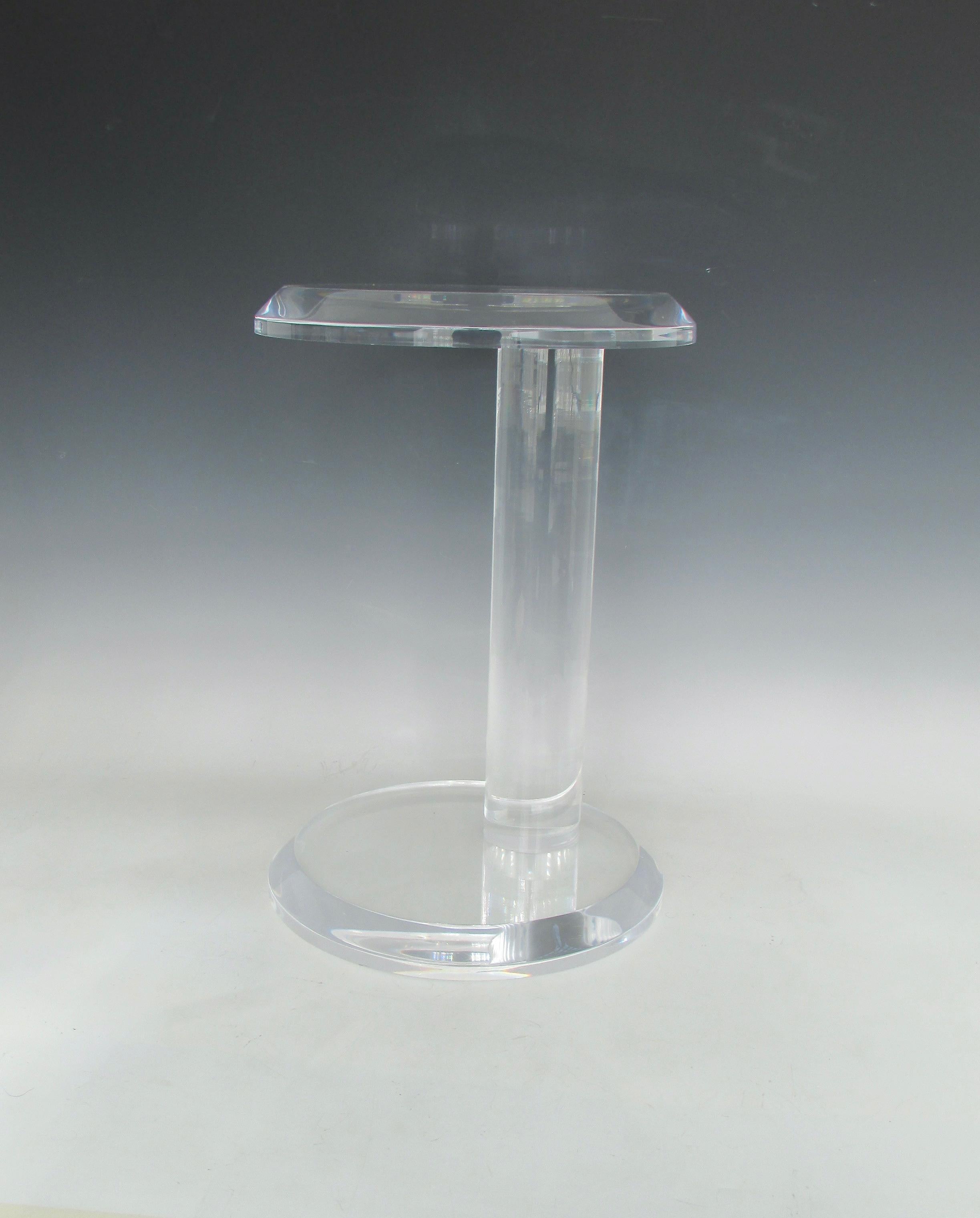 Beautifully and simply designed round top lucite table. Asymmetrically placed round base holds thick acrylic shaft supporting cantilevered matching round top. Jewel of a table.