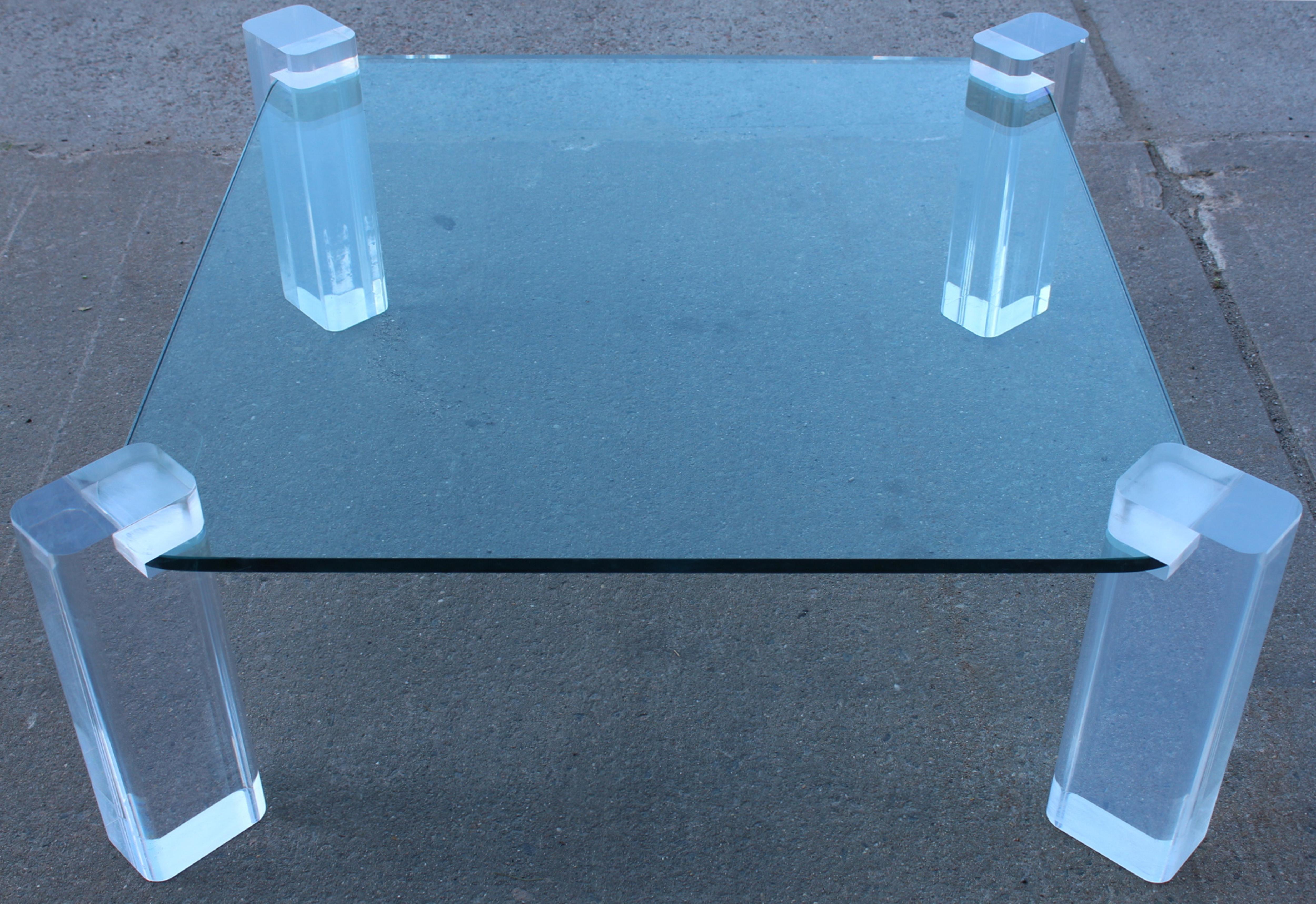 Coffee table after Karl Springer supported by four Lucite block legs. Includes a sheet of .75