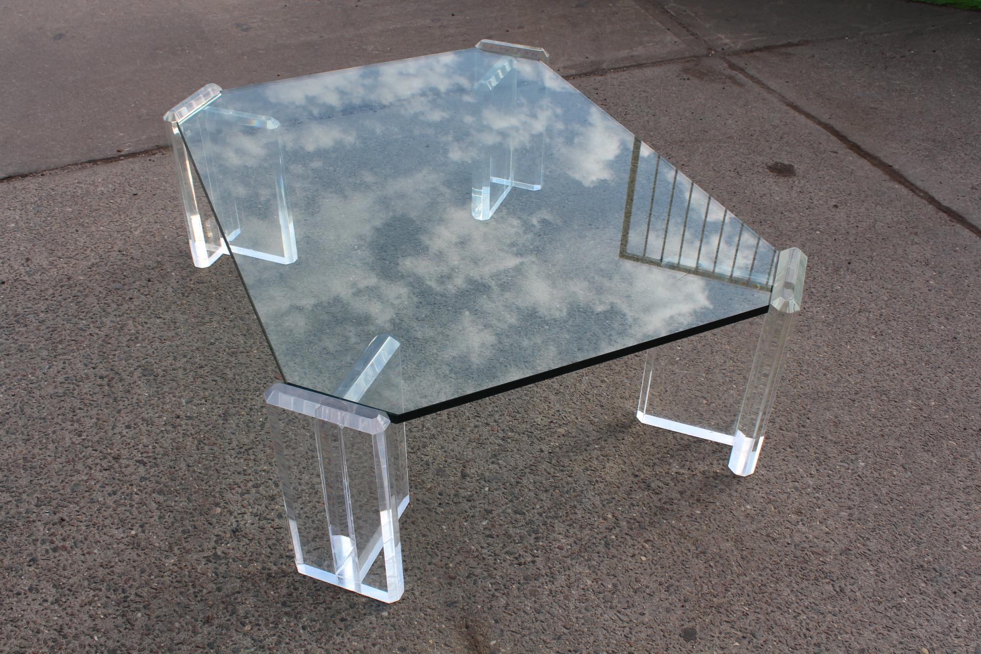 Coffee table after Karl Springer supported by four Lucite block legs. Includes a sheet of .75