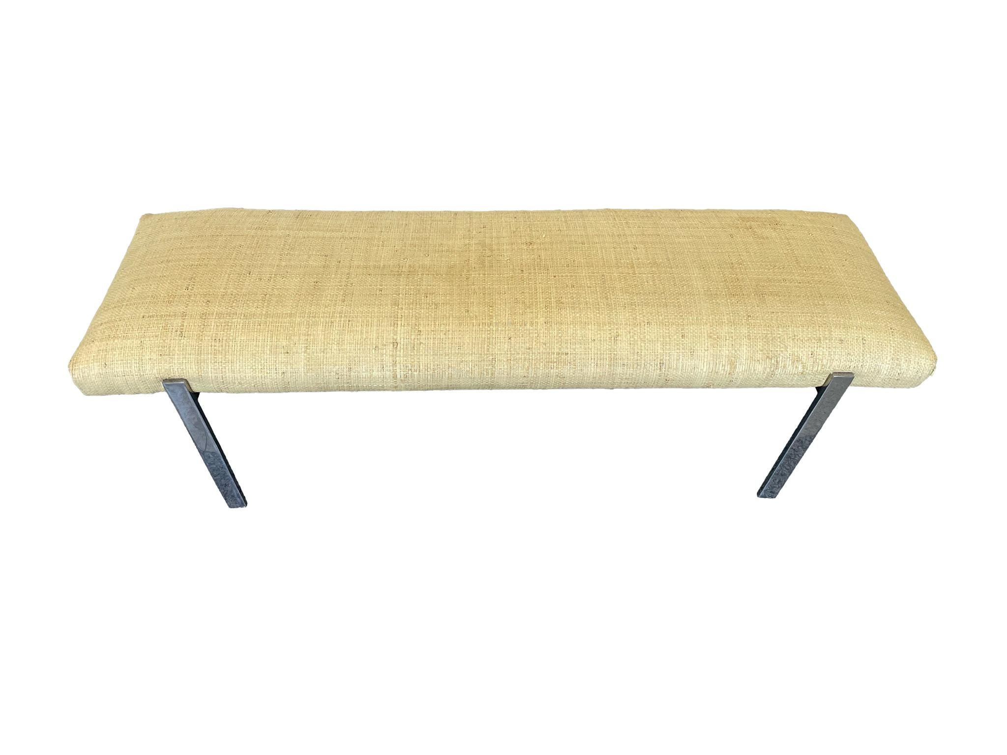 Mid to late 20th Century bench designed in the the style of Karl Springer. Much like his designs, this bench combines a minimalist form with richly textured and contrasting materials. The upholstery is grasscloth, while the legs are chrome.