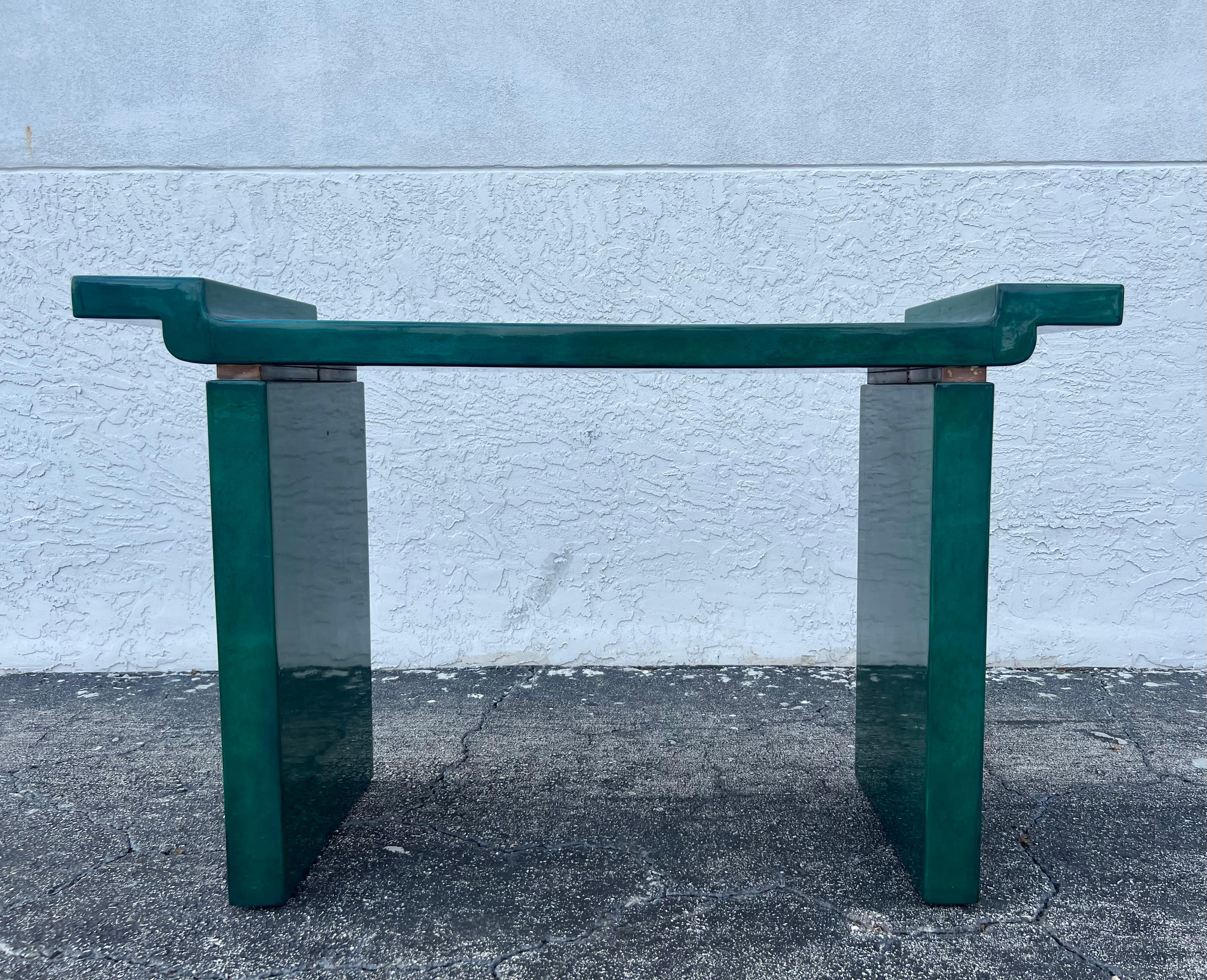 Karl Springer Style green lacquered goatskin console table. Beautiful green tones with brass accents. Patina to the brass and minor touch ups/imperfections to the lacquered finish (please refer to photos). Additionally photos available upon