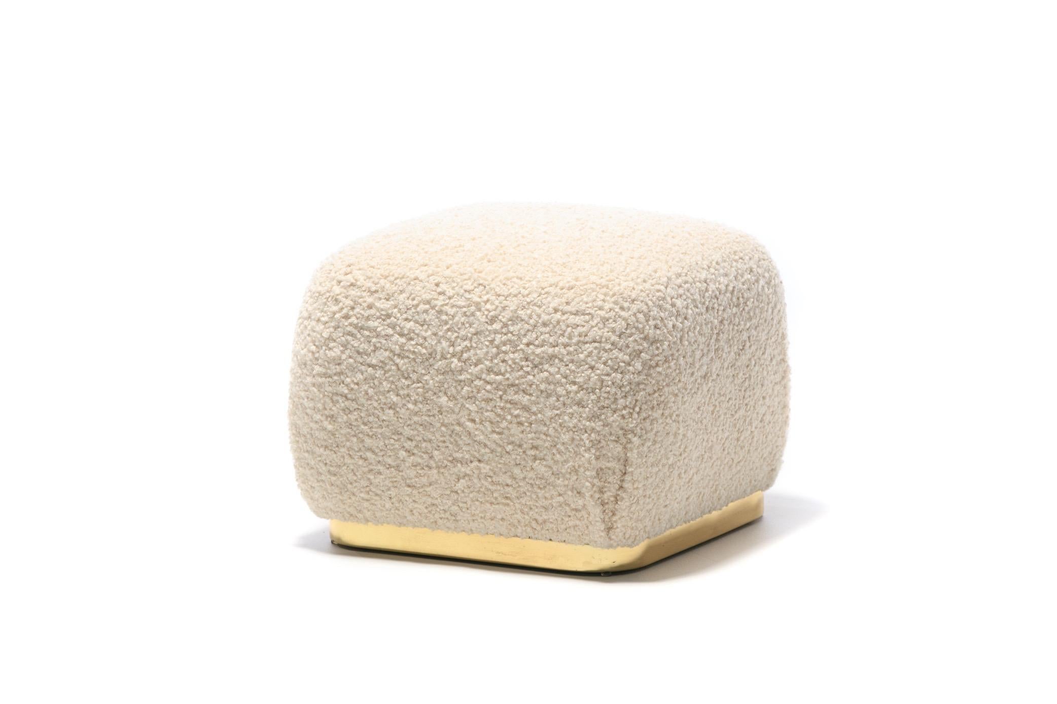 Post modern Karl Springer style Soufflé pouf ottoman aptly named for its similarity in form to a French Soufflé. Brass square base with rounded corners. Professionally reupholstered cushion in softly textured ivory bouclé. An easy addition in a